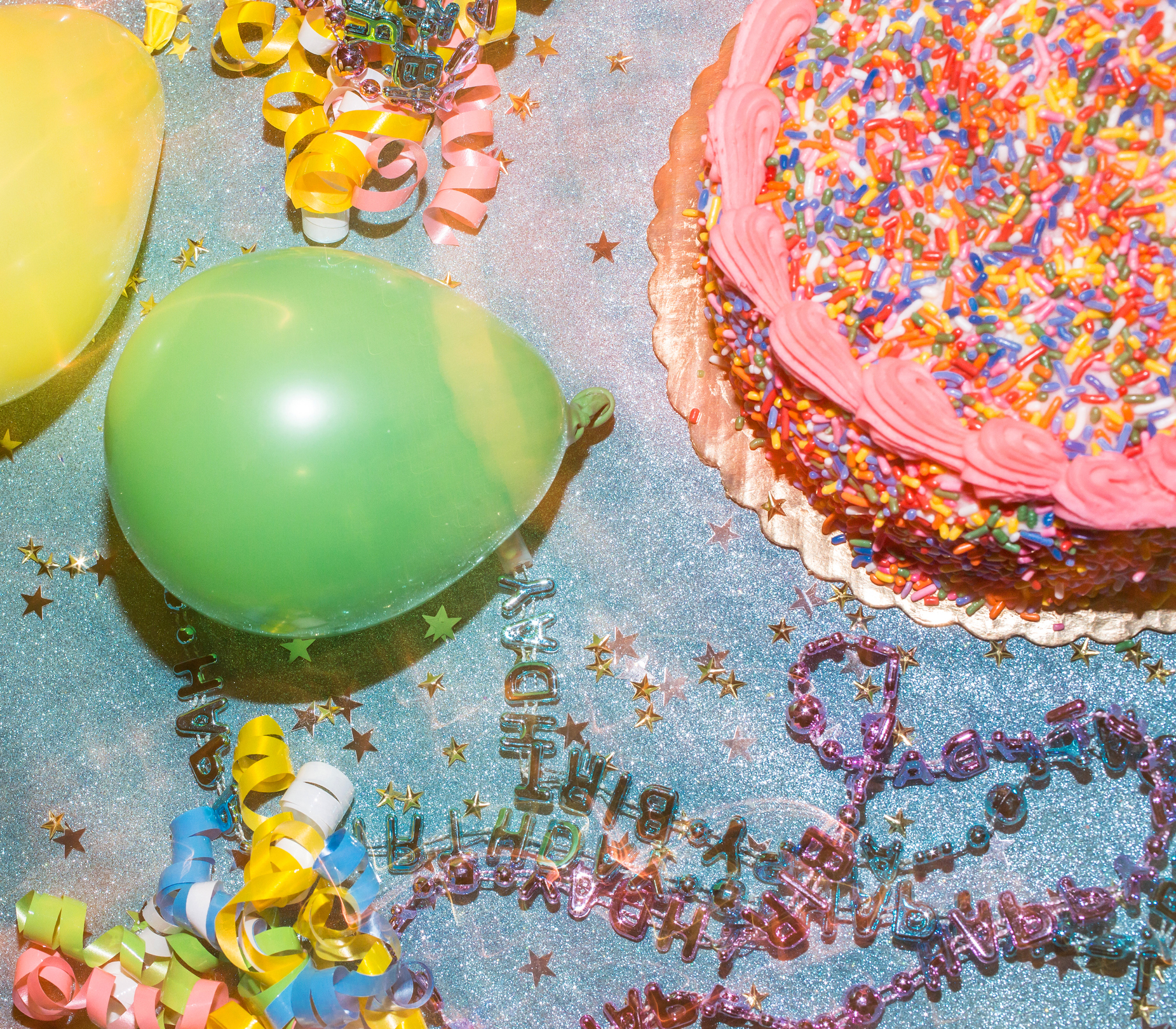 Birthday montage with cake, glitter and green balloon