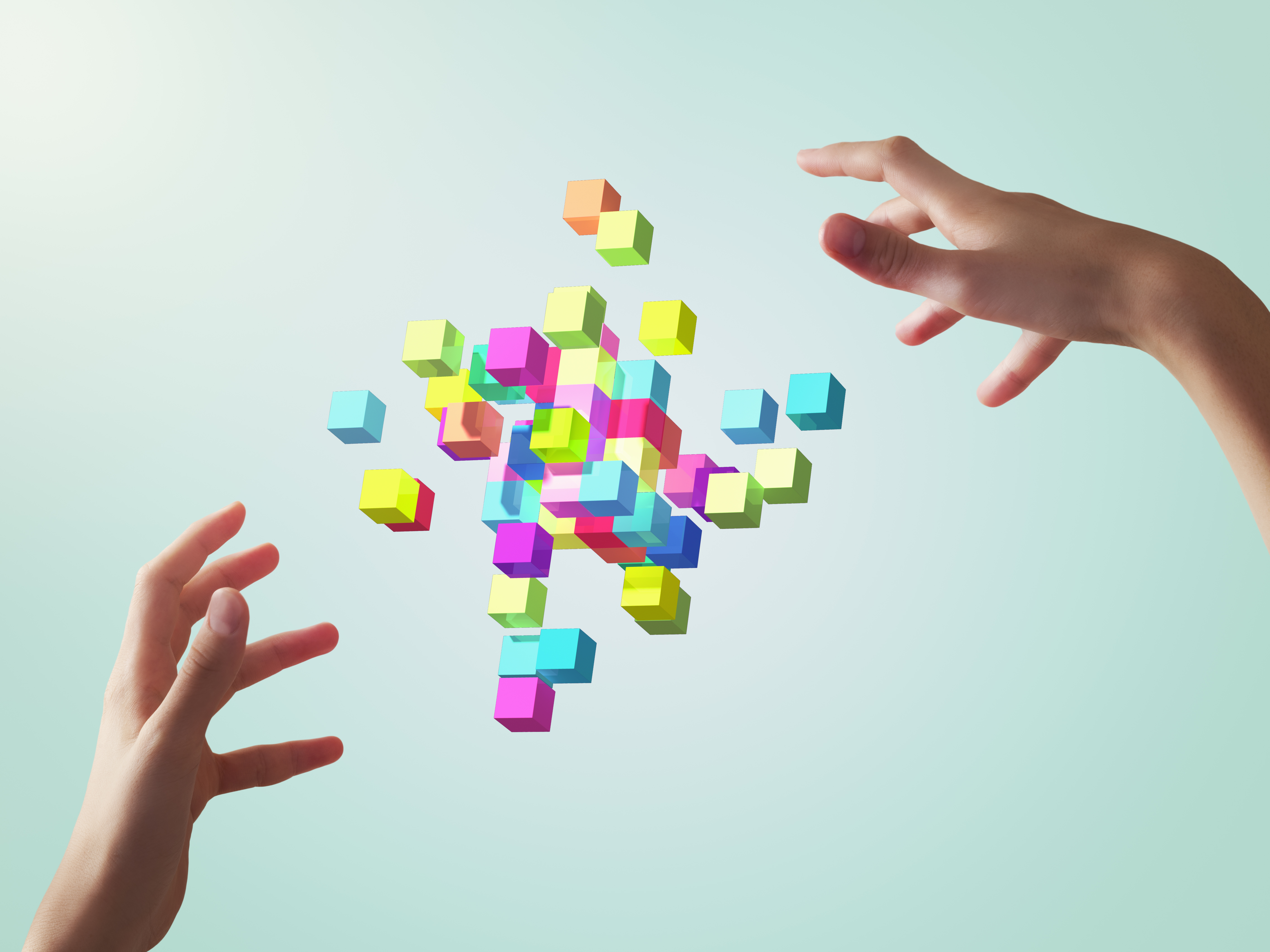 Image of colorful cubes forming geometric shapes between girl's hands.
