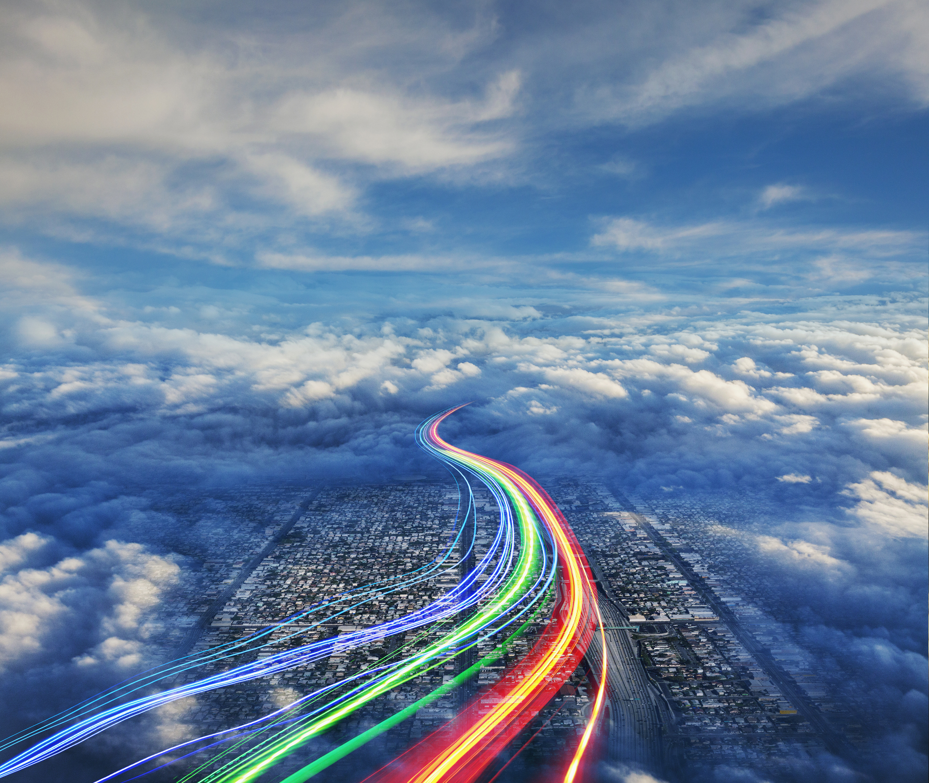 Streaming communications in the form of light trails streak over the city of los Angeles below.