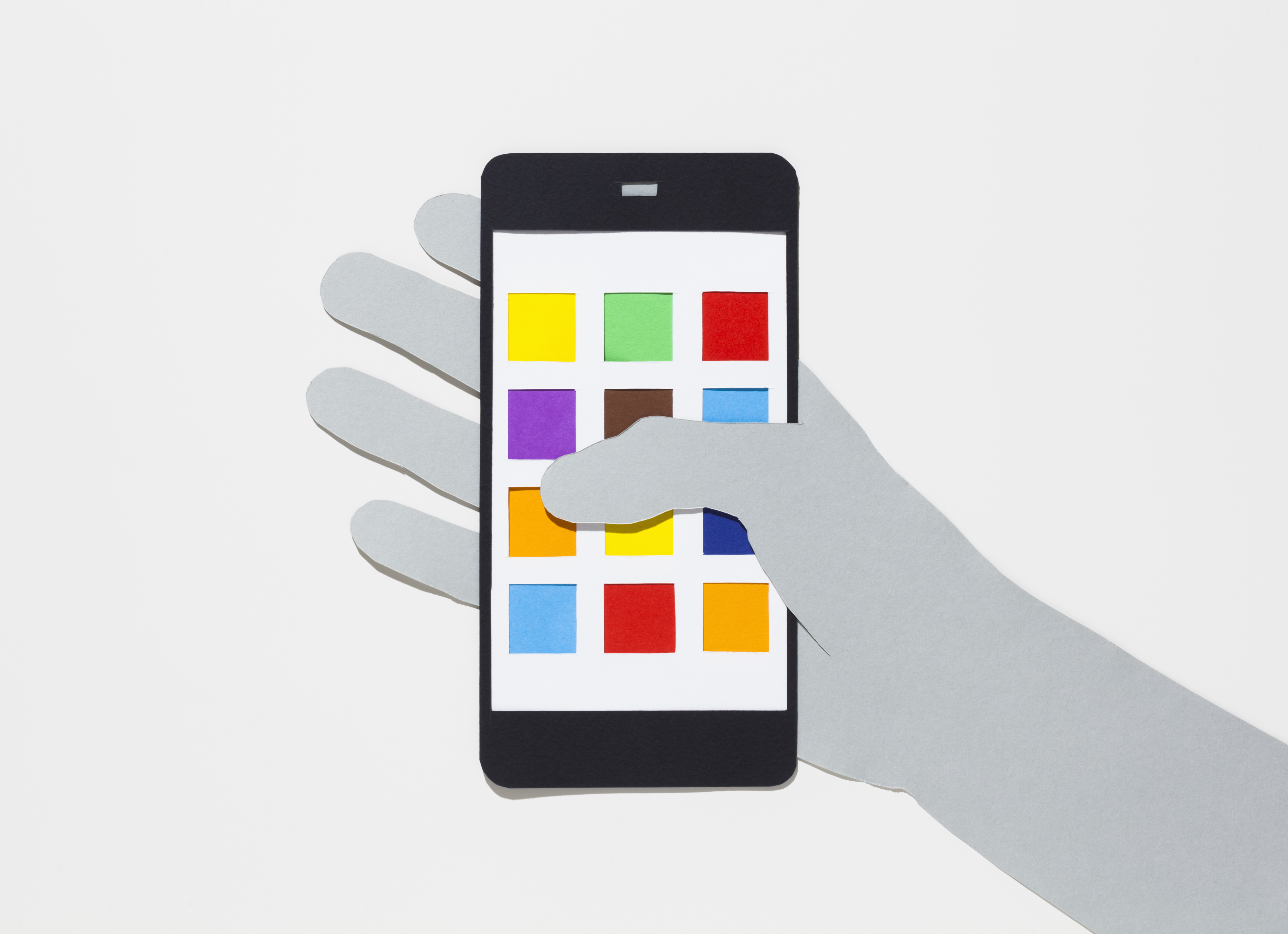 Image of a hand holding a smartphone with multicolored app squares.