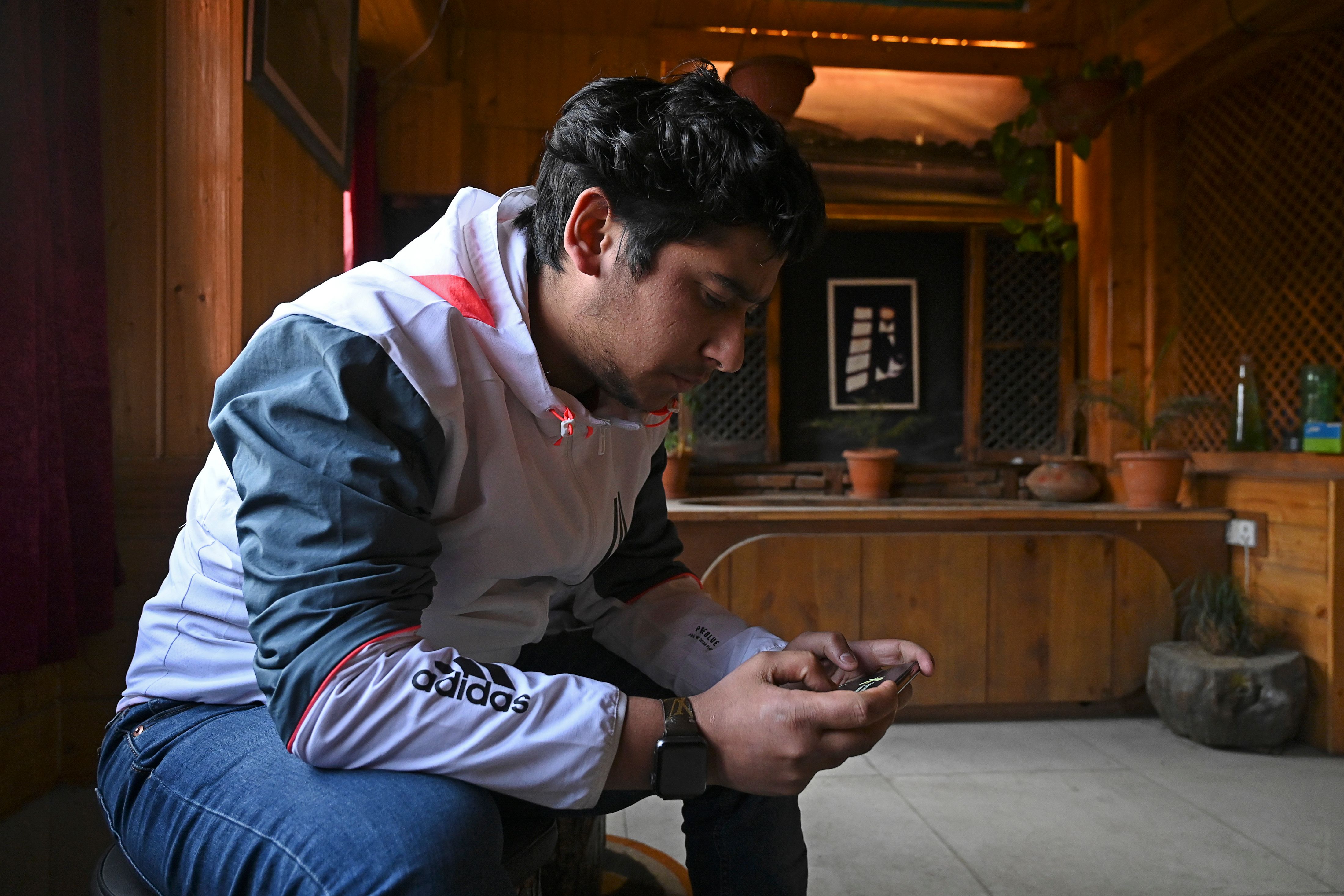 seated man looking at ell phone