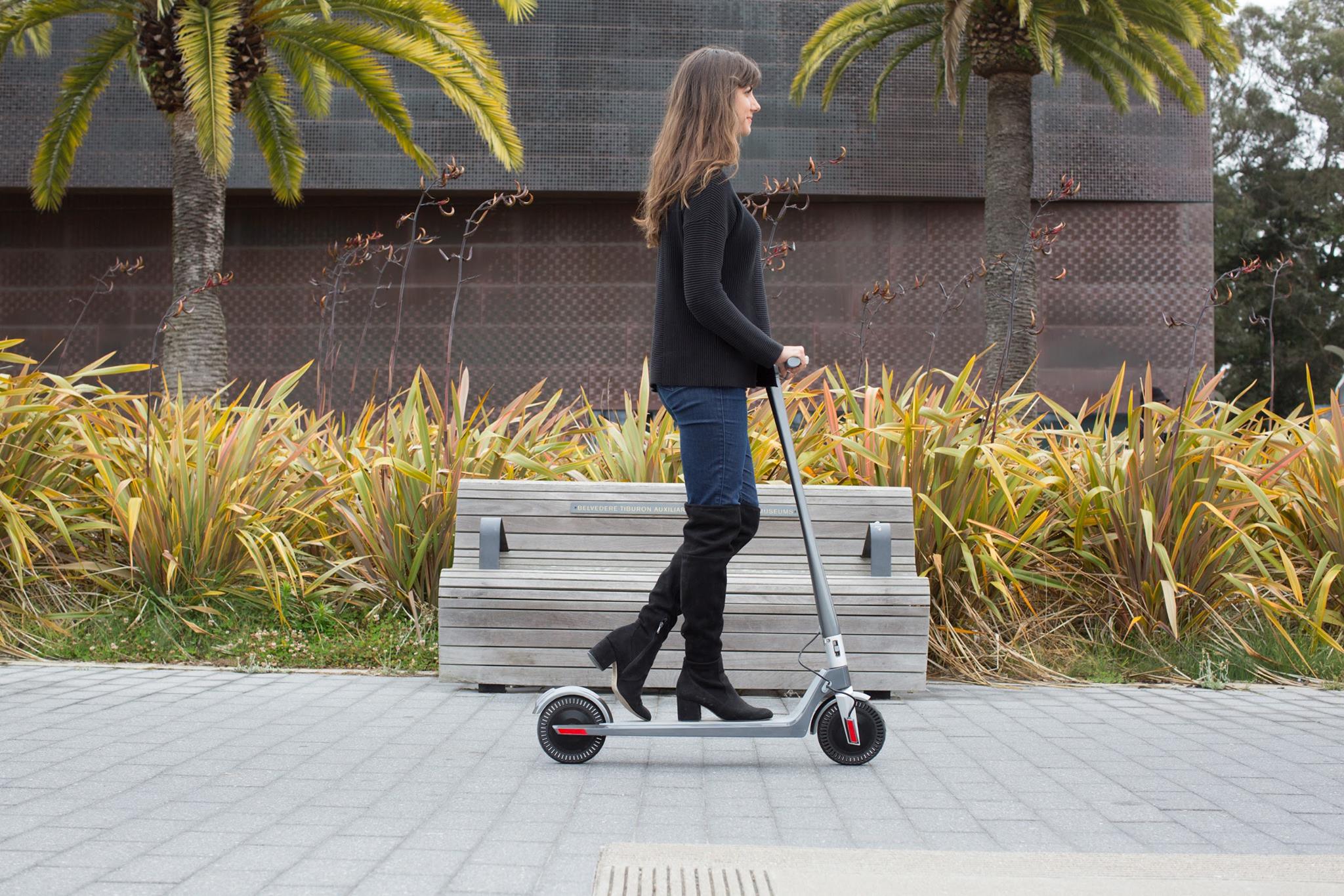 woman riding unagi escooter