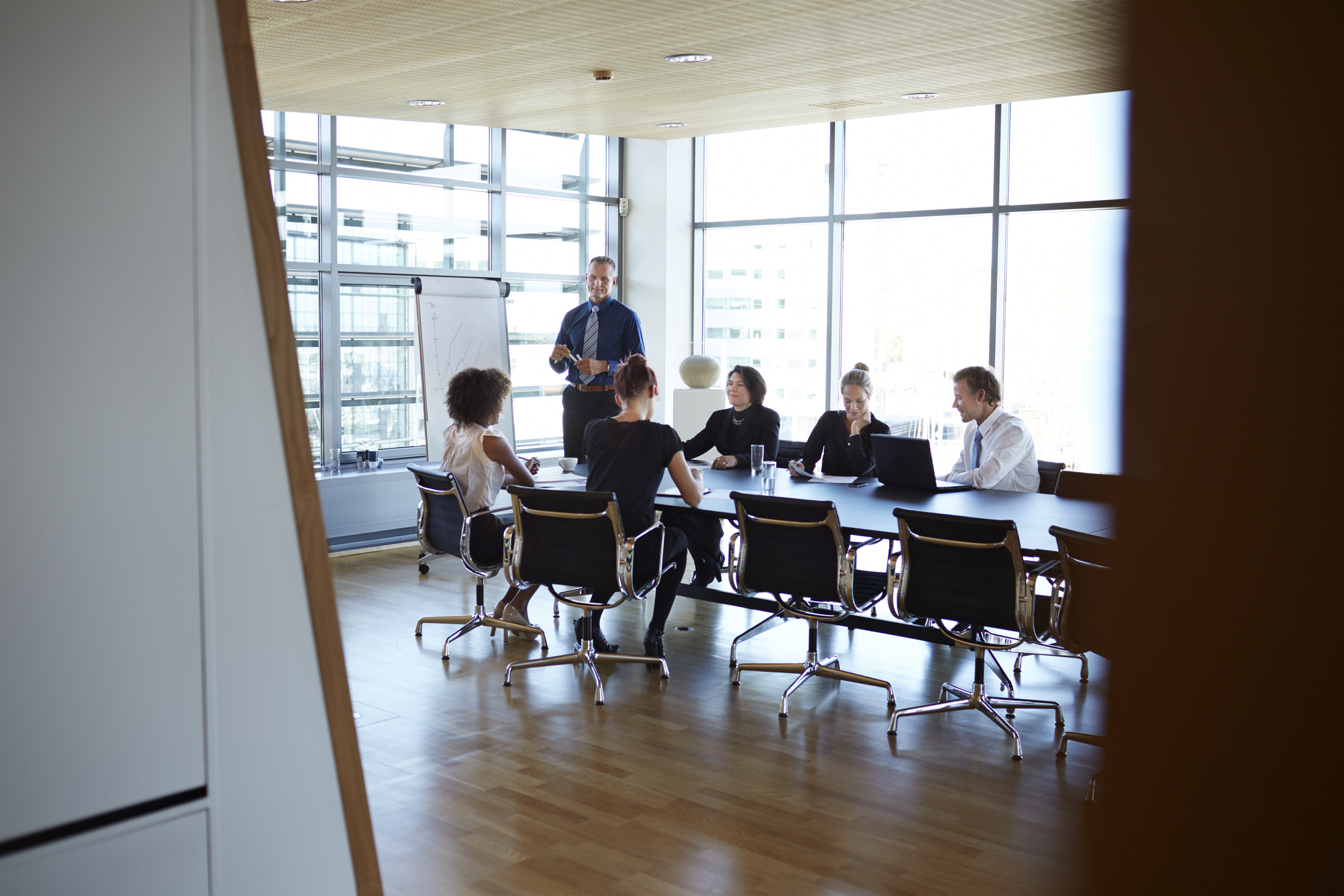 Large group of corporate business people in a meeting in a modern conference room.