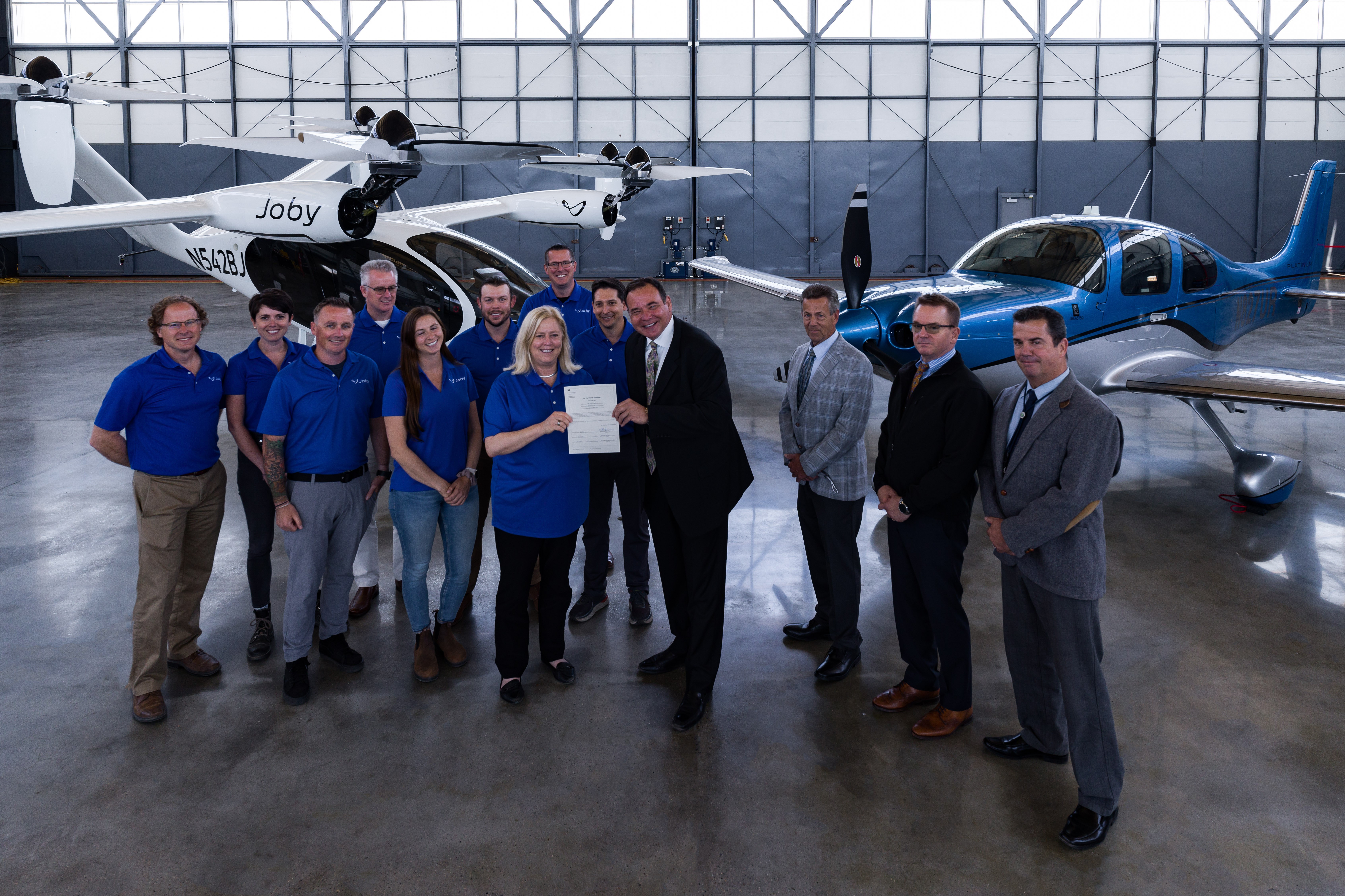 Joby Aviation crew in hangar in front of eVTOLs