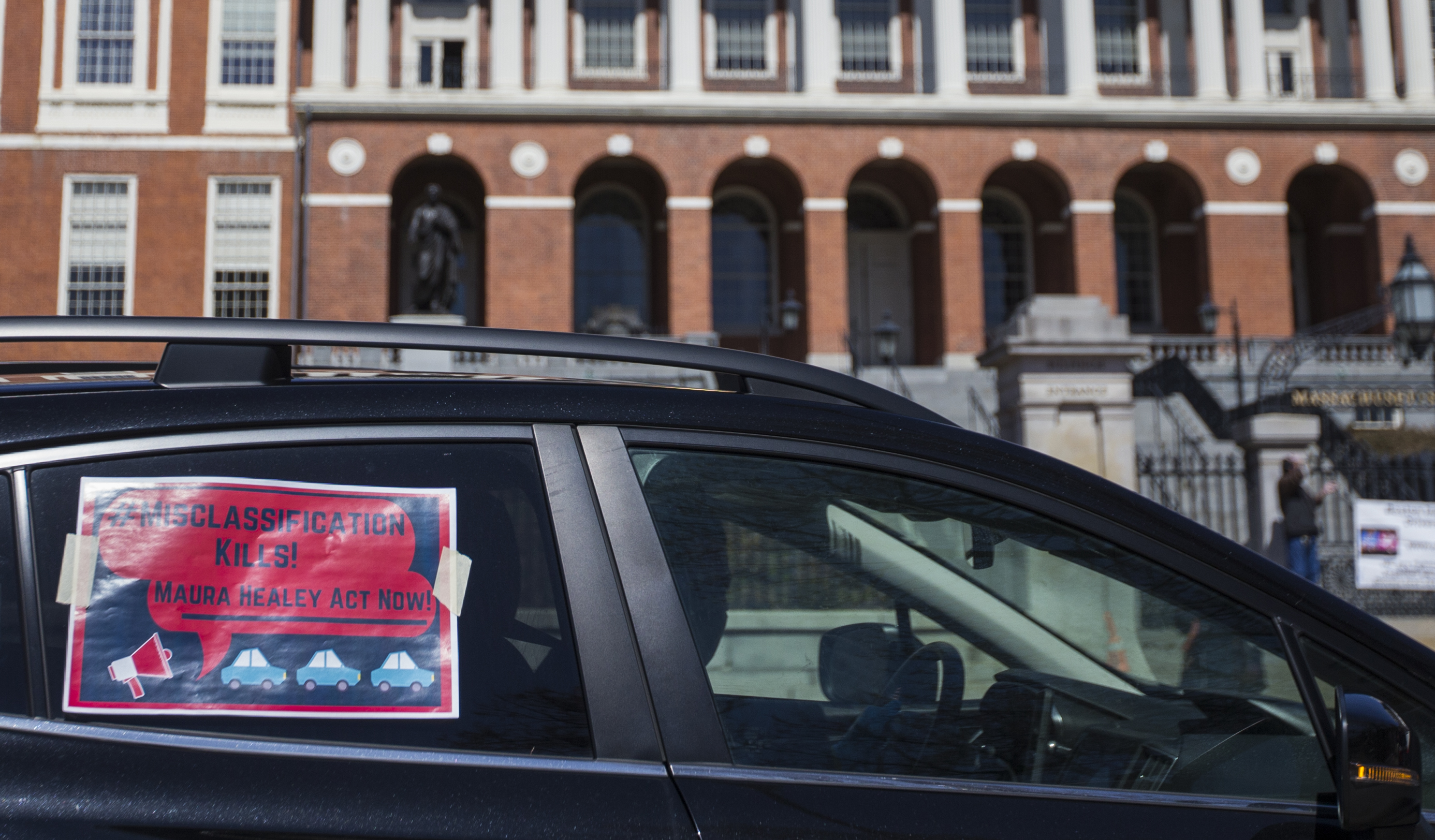 Uber and Lyft drivers participate in a "rolling rally" around the Boston Common on April 6 to protest the classification of ride share drivers as independent contractors, which limits their ability to apply for unemployment despite the coronavirus keeping most of their customers indoors.