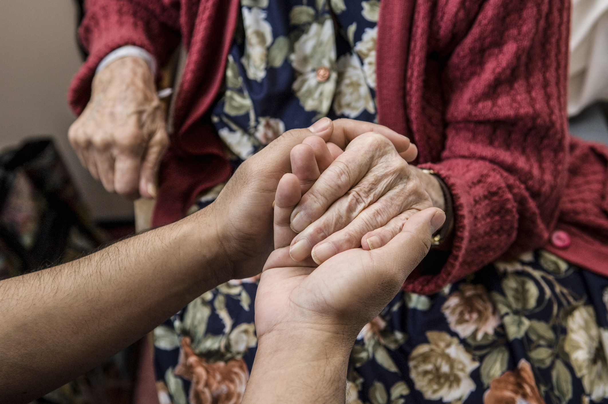 Nurse holding hands with elderly patient.Nurse holding hands with elderly patient, used in a post about August Health