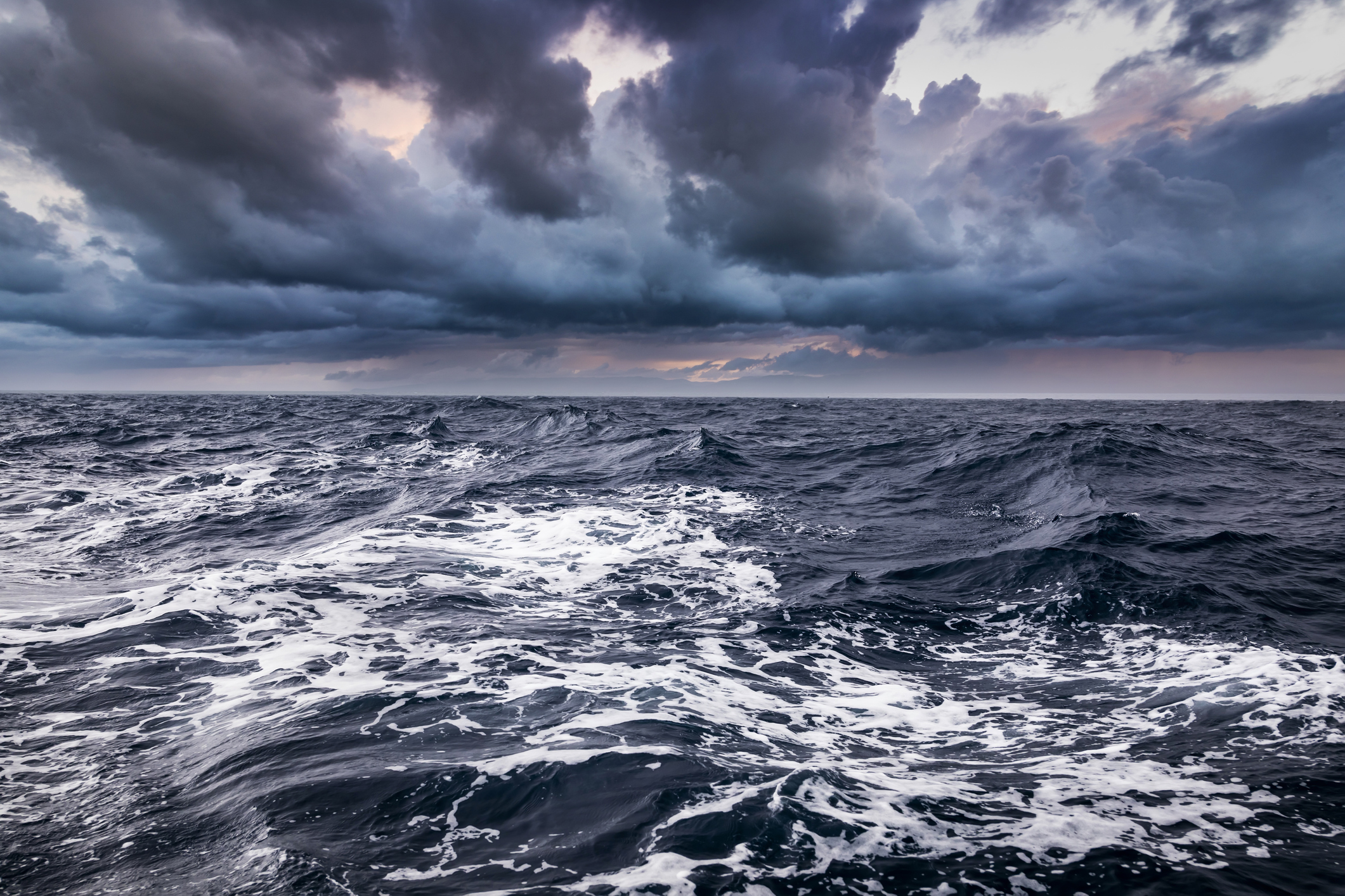 Storm on the sea with dramatic clouds at sunset