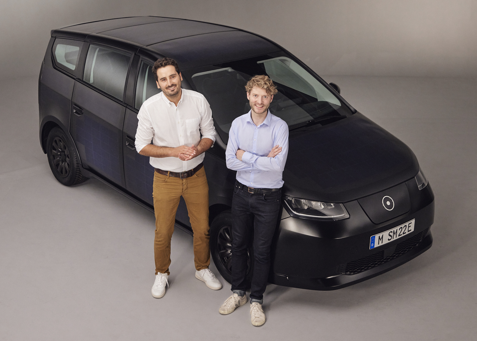 Sono Motors co-founders Jona Christians and Laurin Hahn posing in front of Sion EV