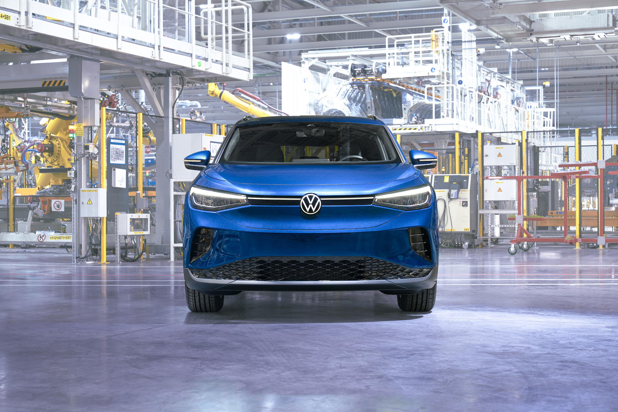 Front of a blue 2023 VW ID4 parked in a factory.