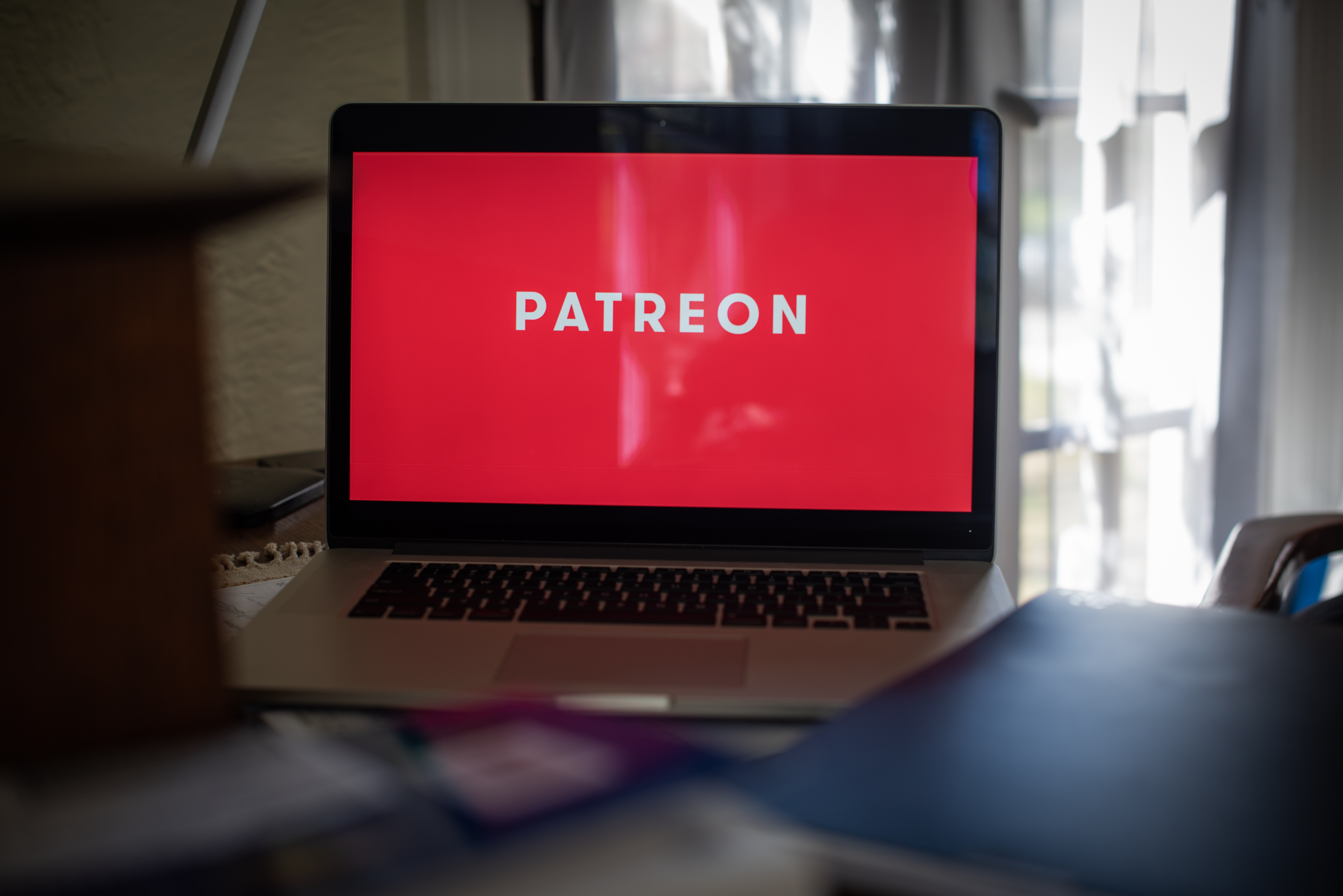 The Patreon Inc. logo on a laptop computer arranged in Dobbs Ferry, New York, U.S., on Tuesday, April 13, 2021. More than 200,000 artists and entertainers use Patreon Inc. to connect with and raise money from fans. That momentum has helped the company raise some money of its own. Photographer: Tiffany Hagler-Geard/Bloomberg via Getty Images