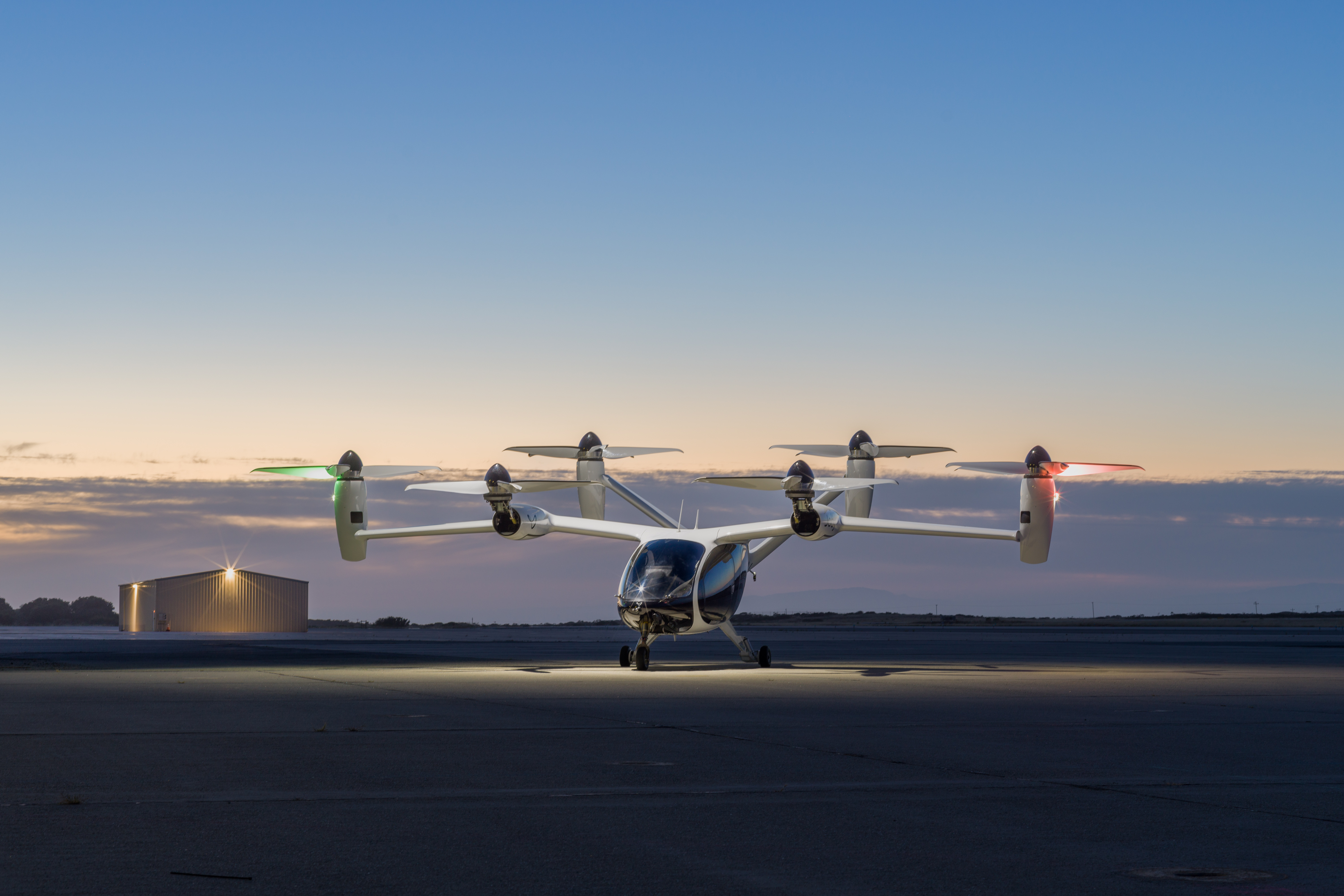 electric vertical takeoff and landing vehicle at a marina at sunset