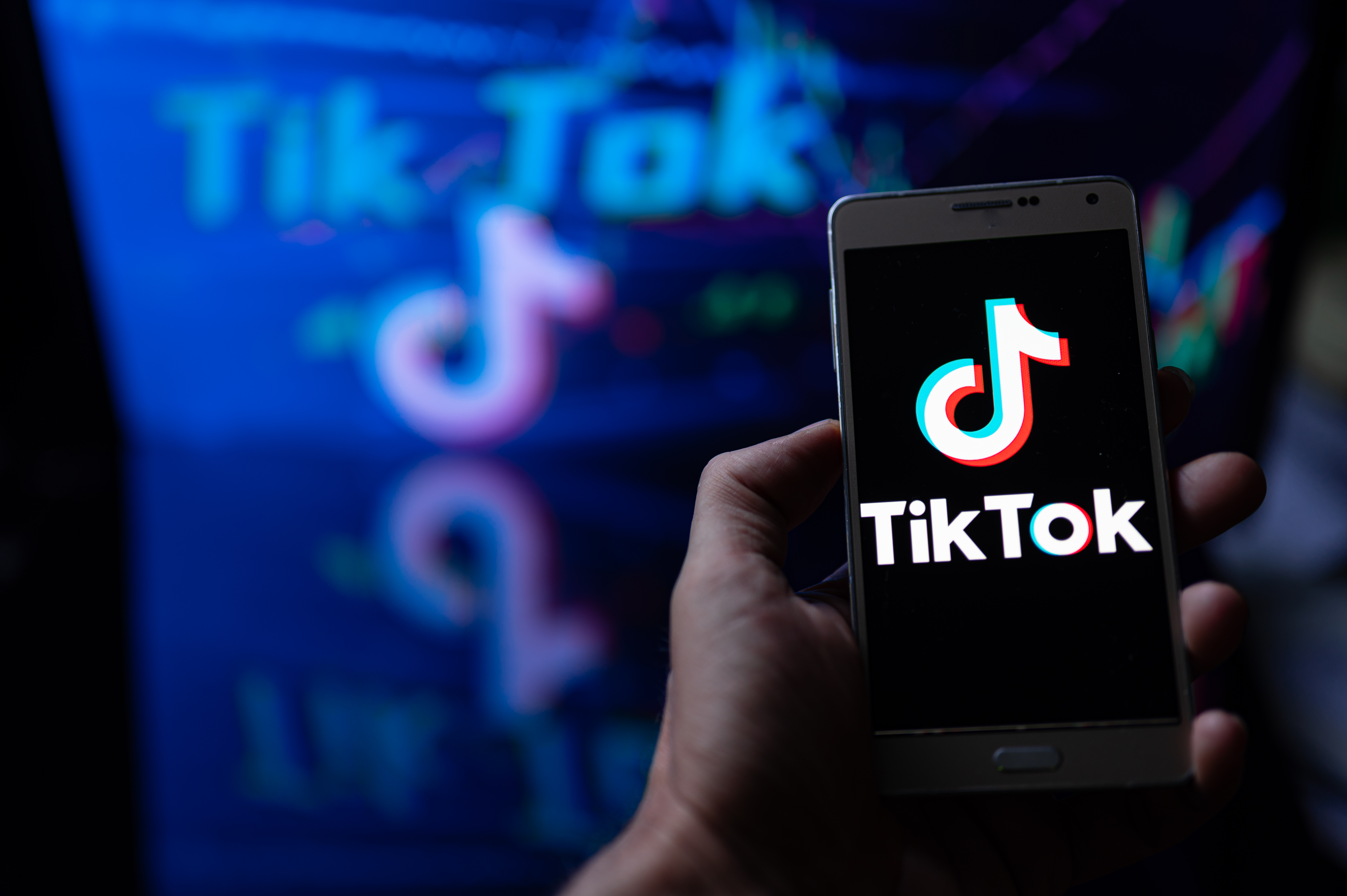 TikTok logo displayed on smartphe held in hand