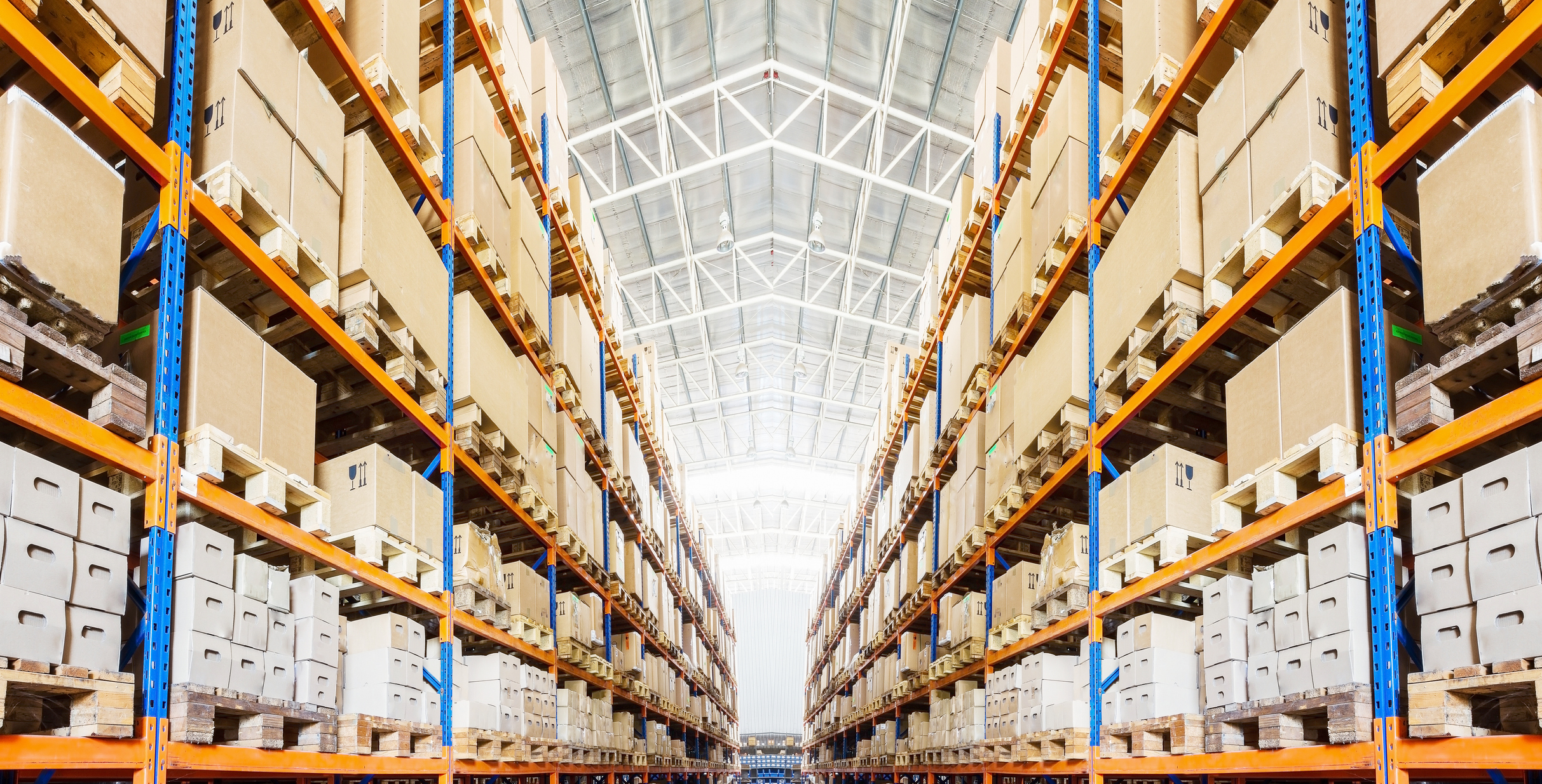 Rows of shelves with boxes in modern warehouse