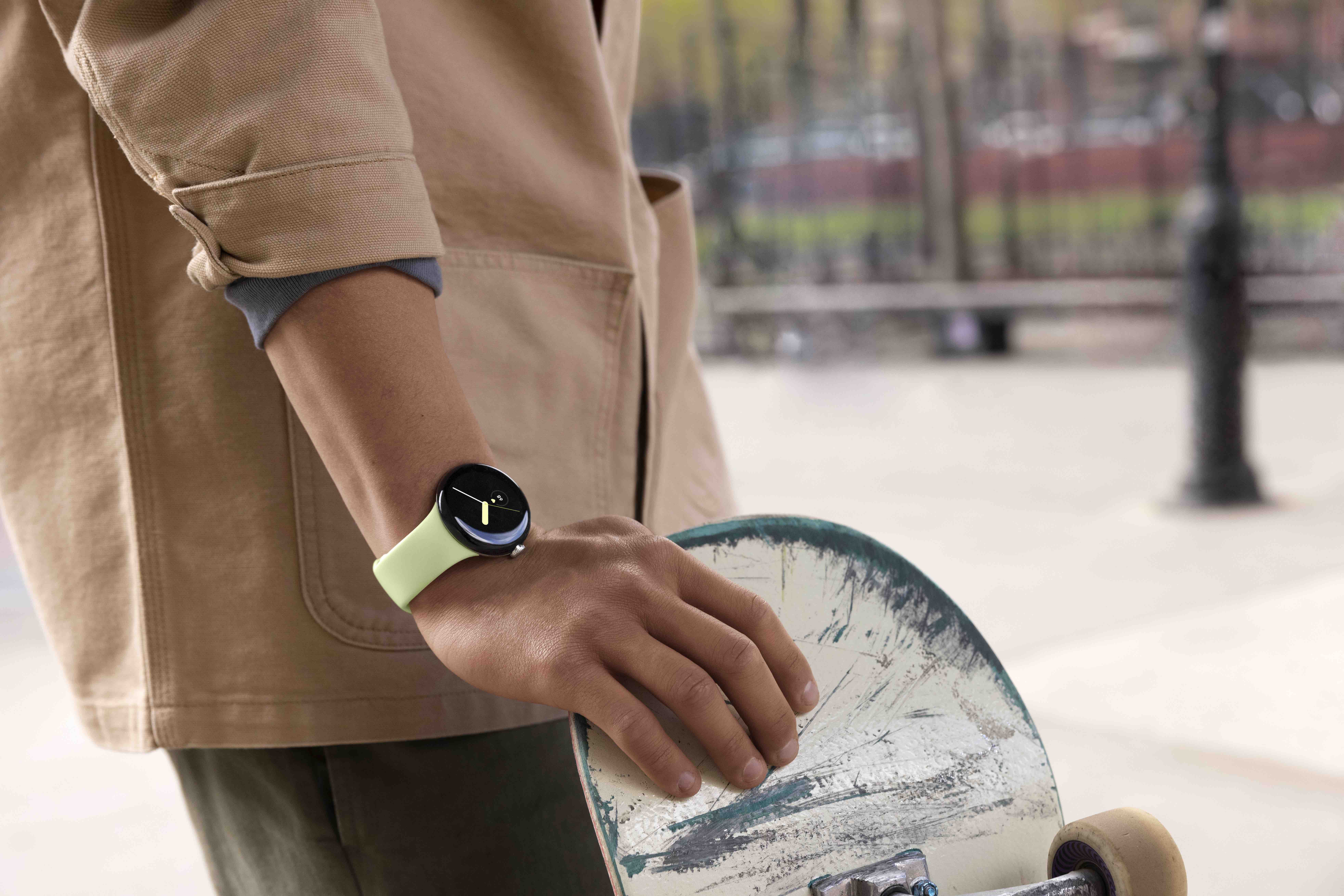 person wearing Google Pixel Watch, holding a skateboard