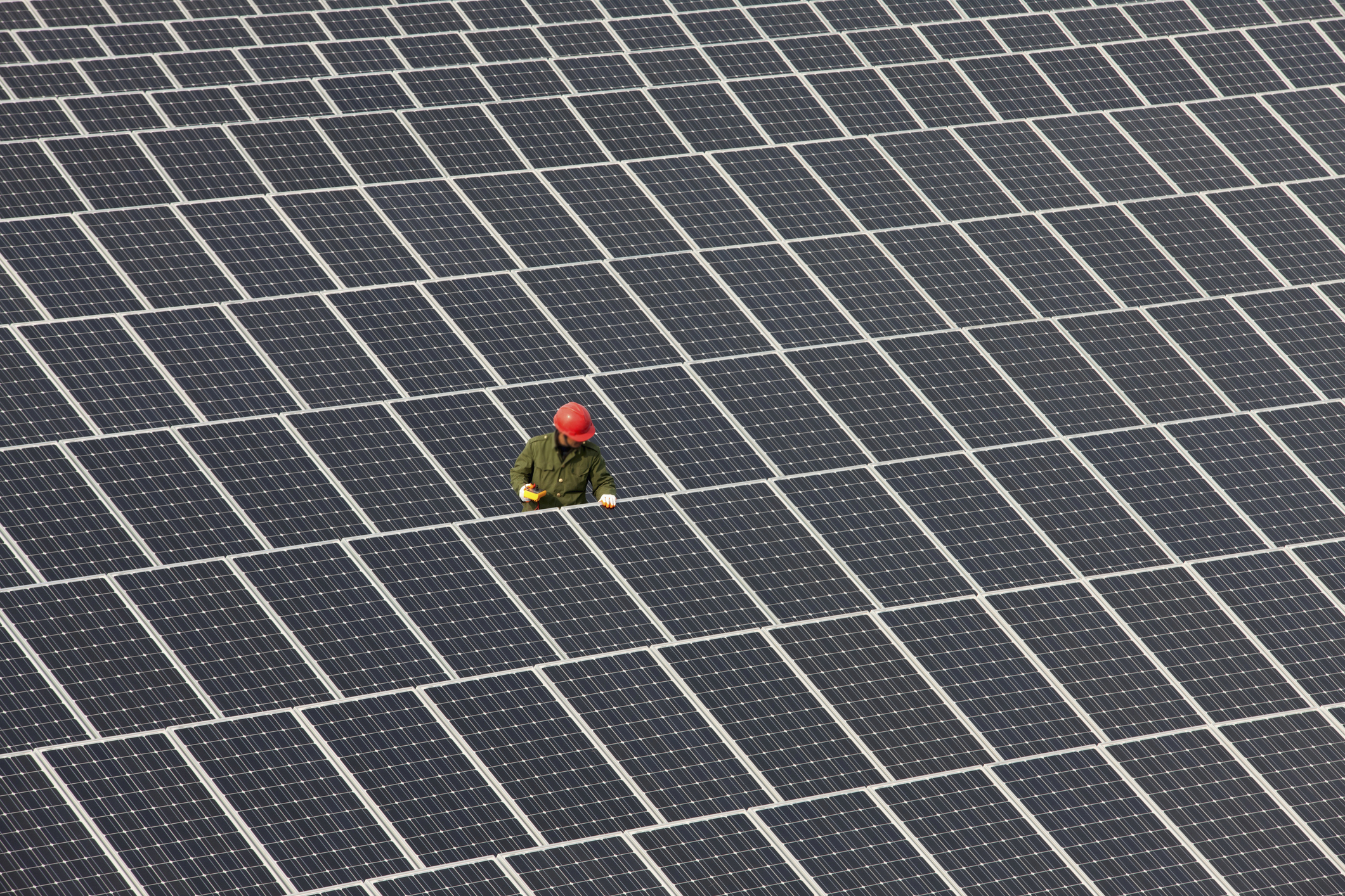 Man inspecting solar panels.