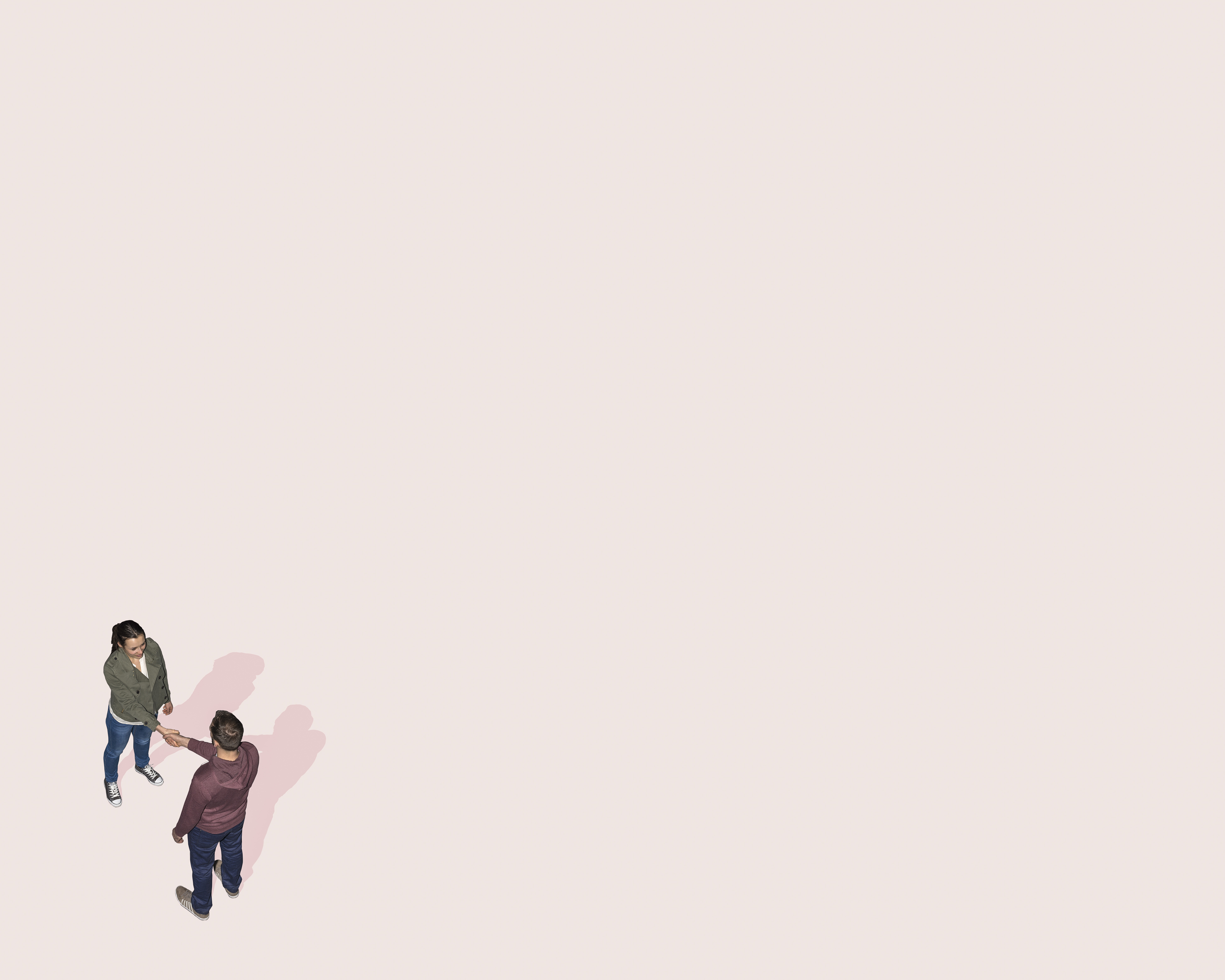 Image of two people shaking hands against a pink background.