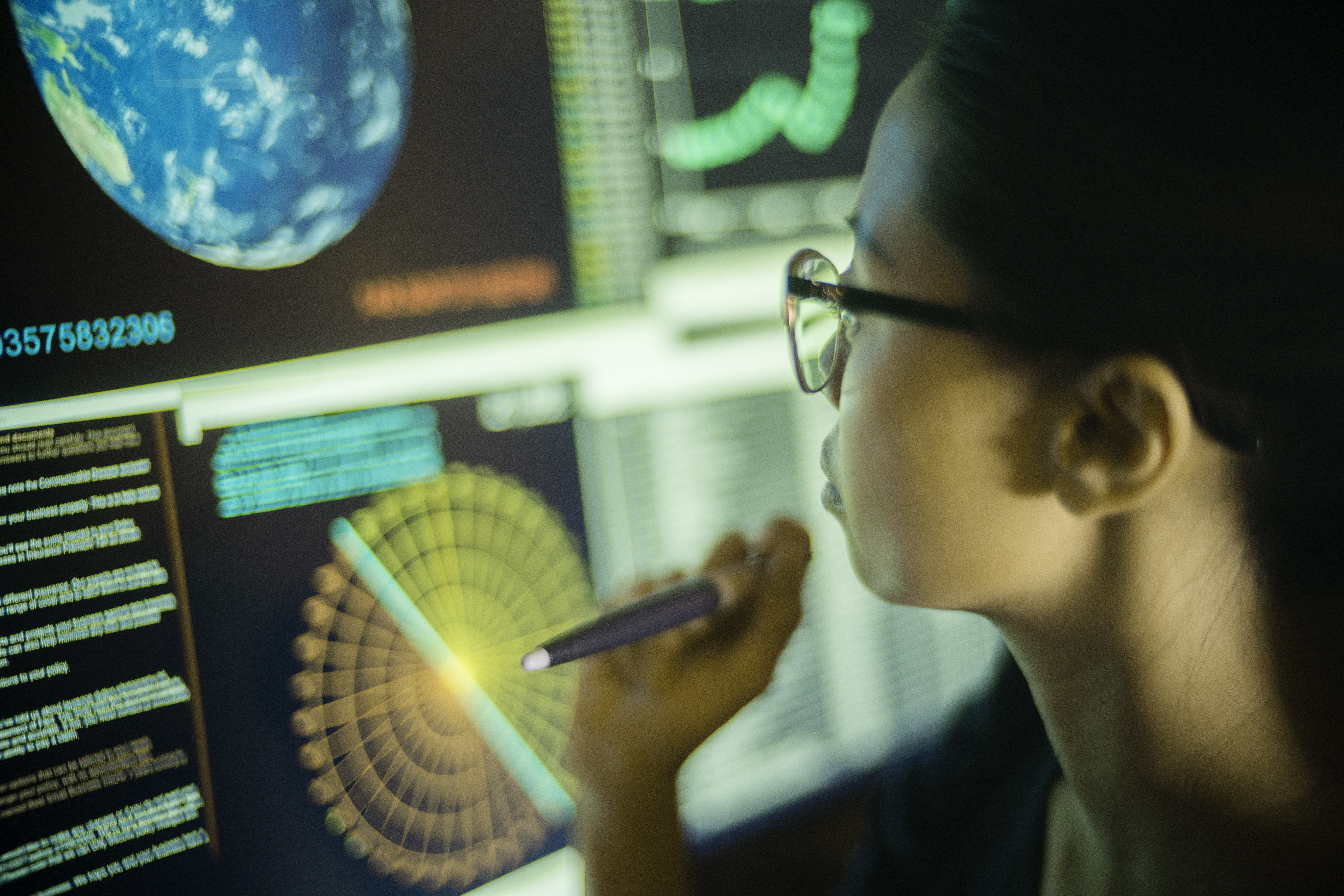 Woman looking at a screen of Earth monitoring data.