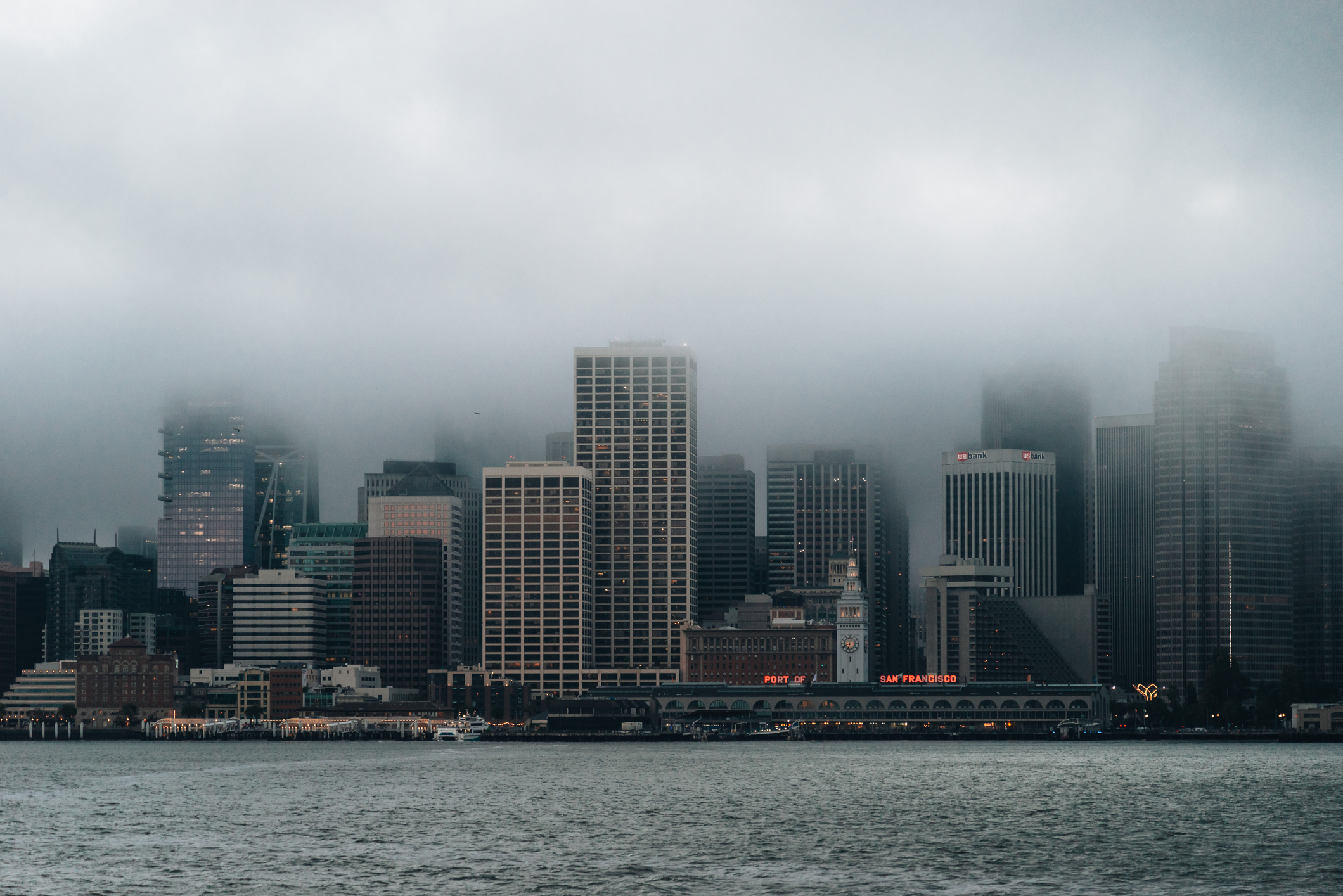 Skyline of SF partially covered in low-hanging clouds.