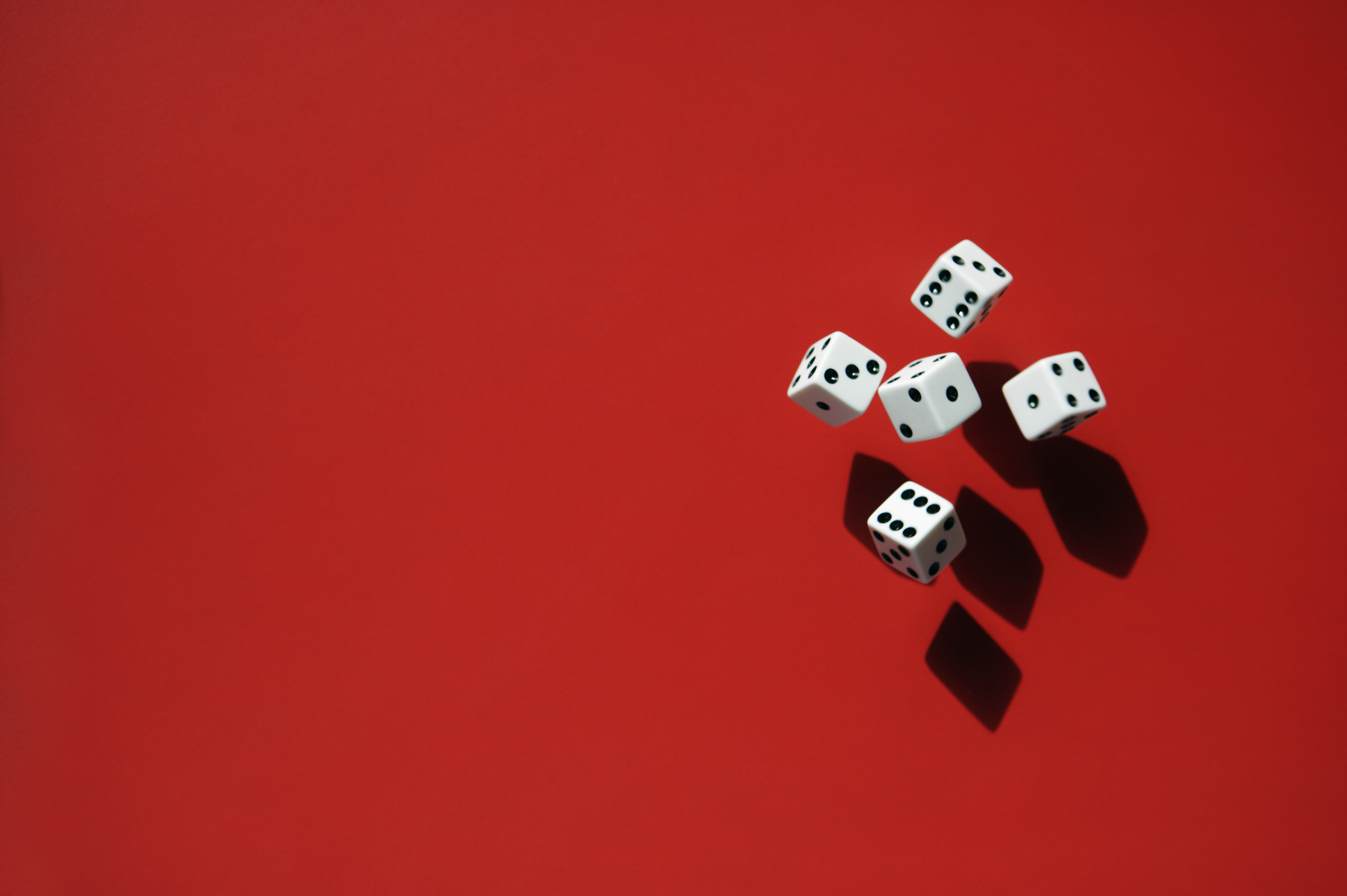 Image of five dice against a red background