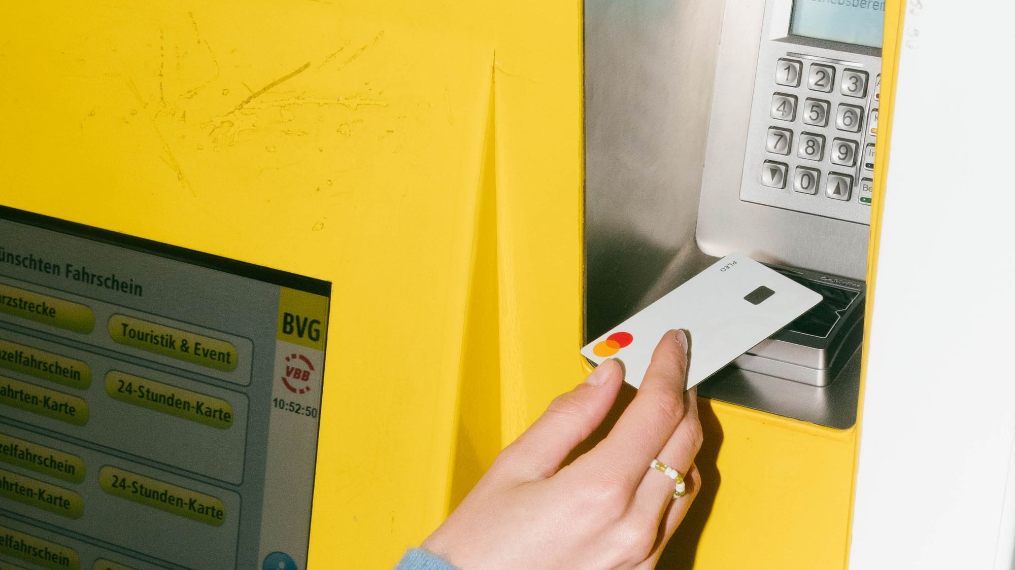 Person insering credit card into ATM machine
