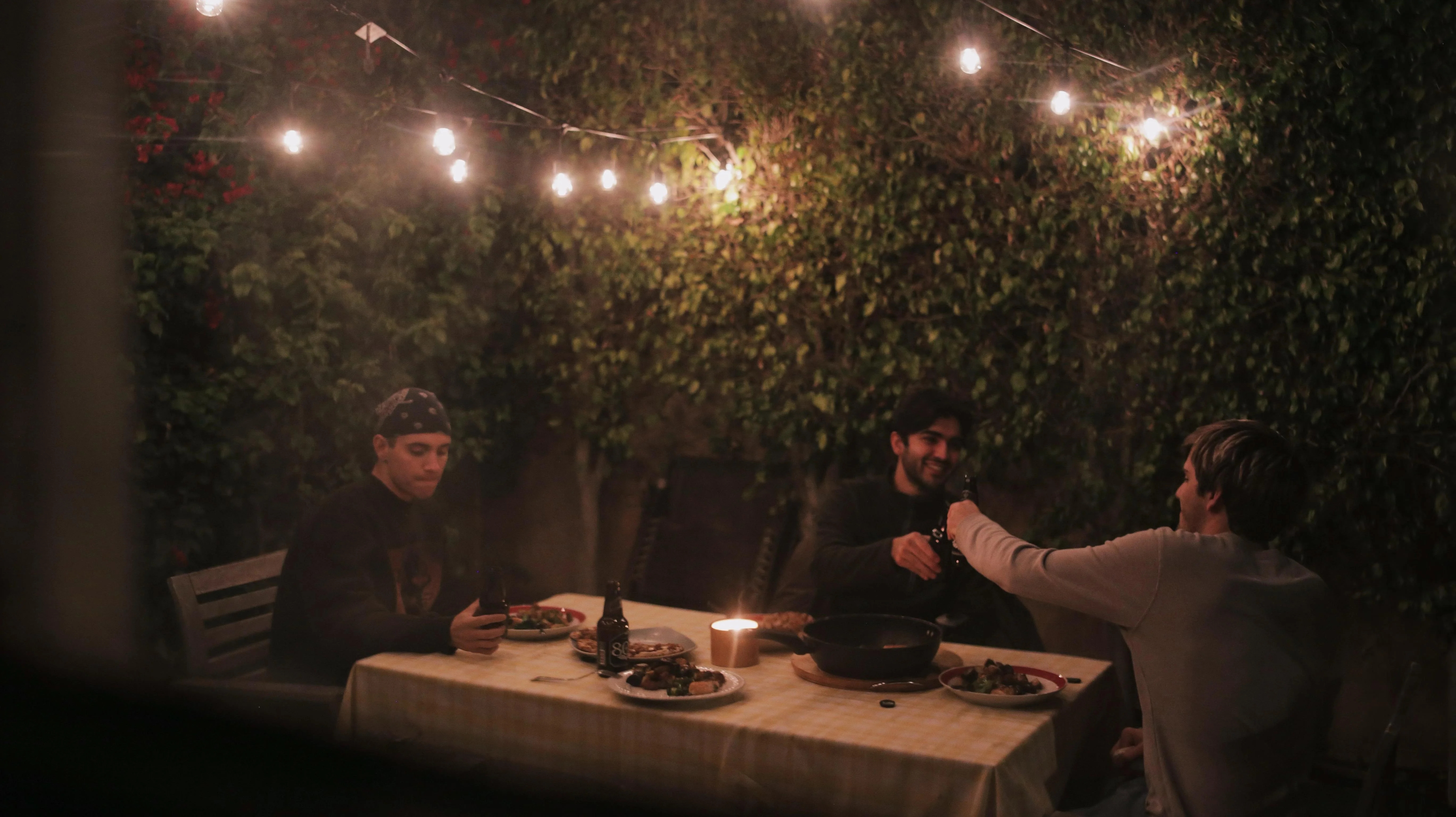 3 men sitting at a dinner table