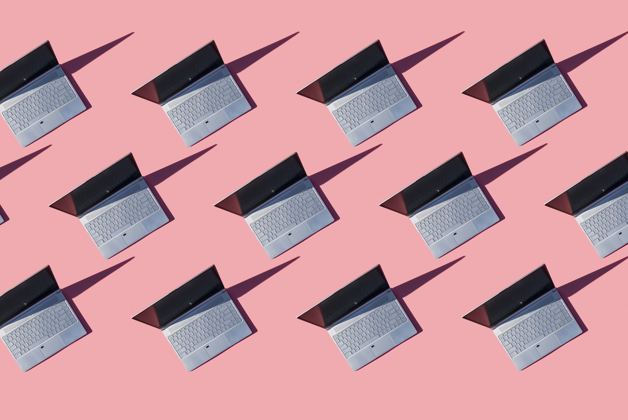 Laptops on pink background