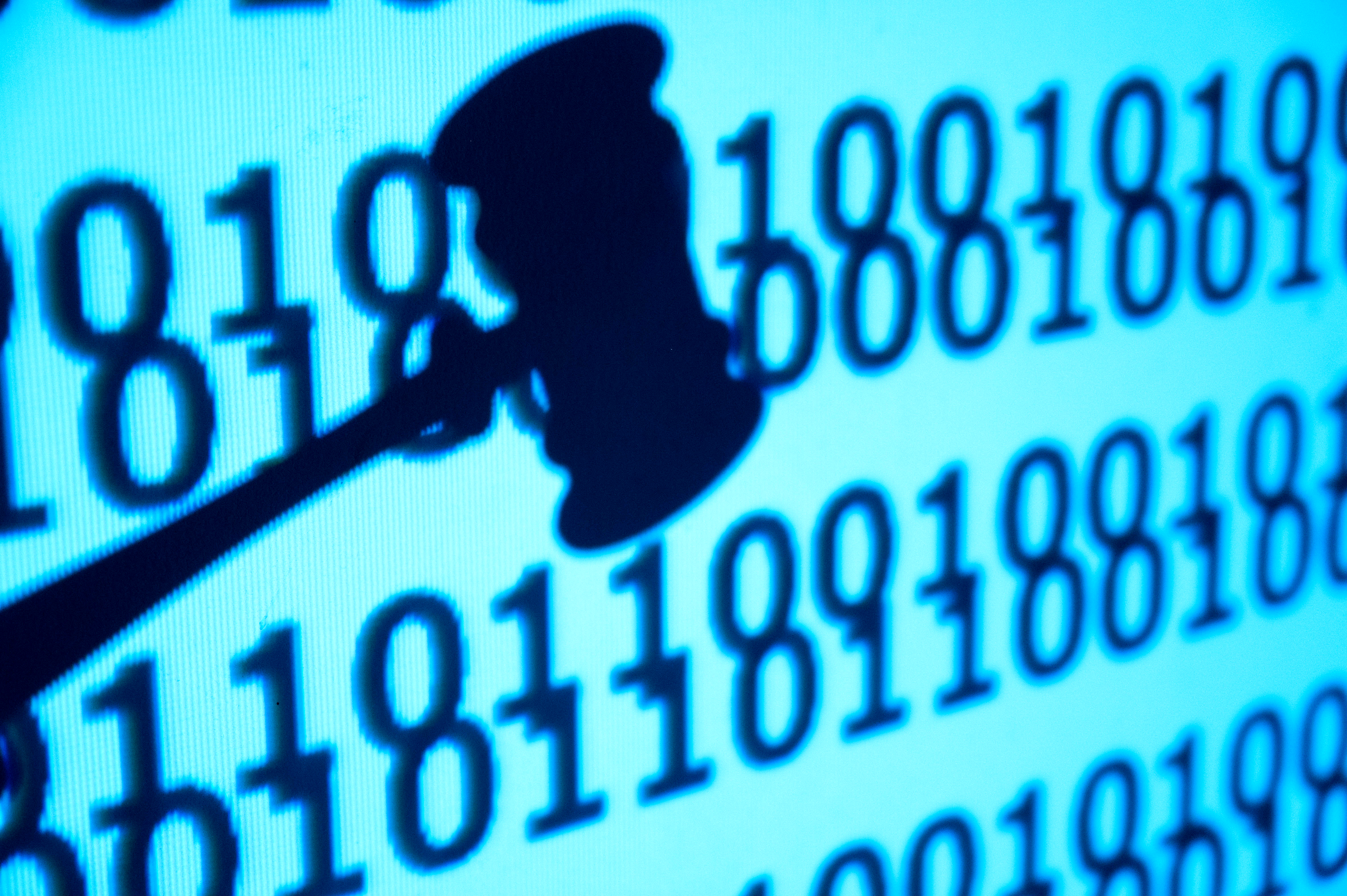 An image of a close up gavel in front of code, concept of justice and lawsuit