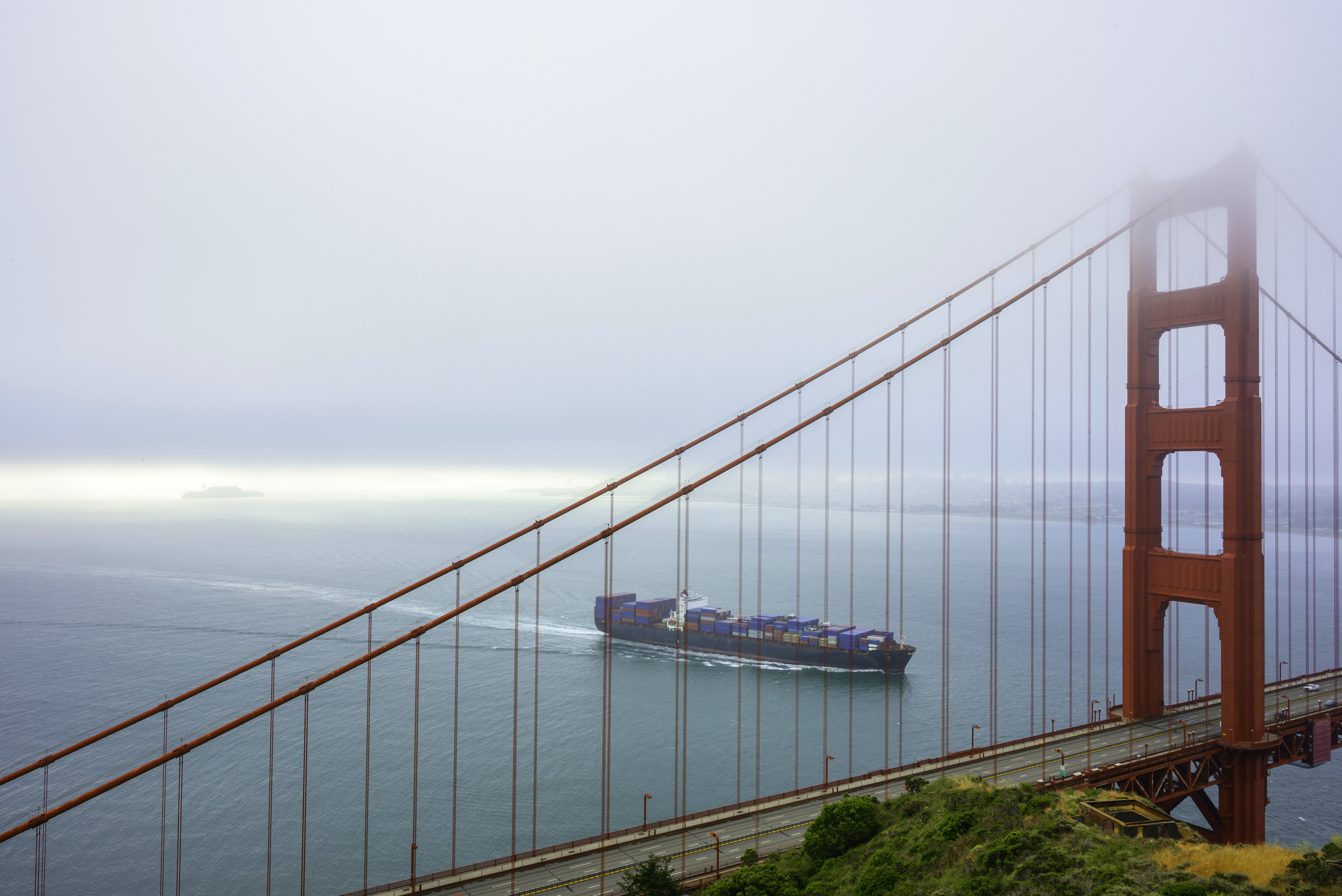 Cargo ship passing under the Goden Gate Bridge