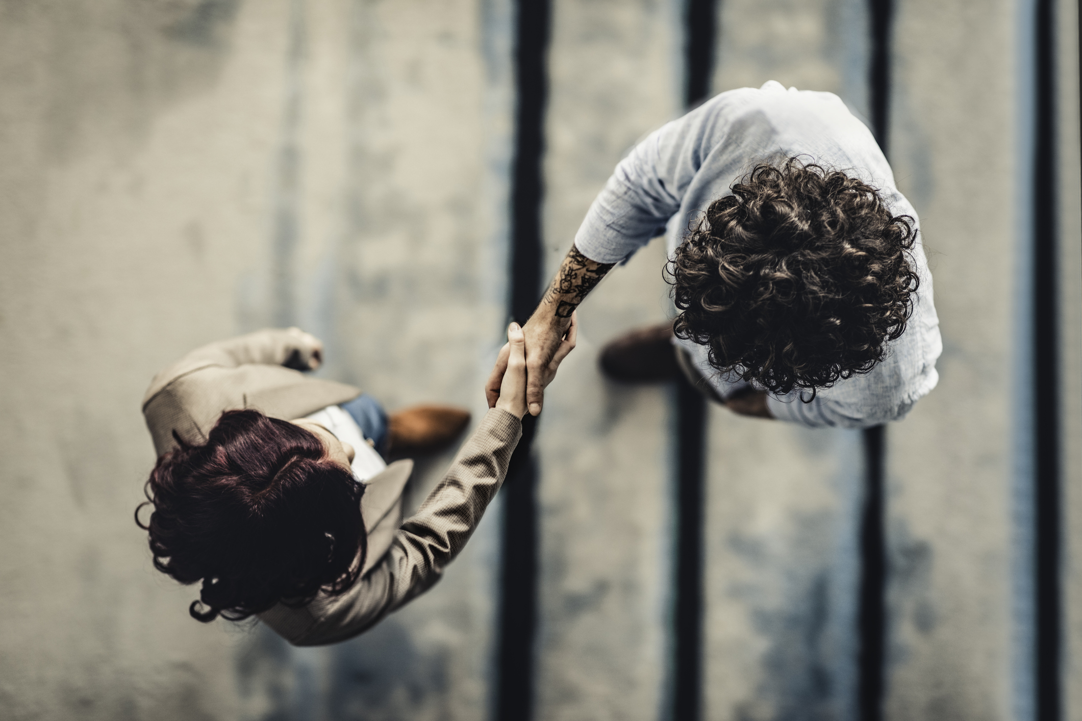 Overhead shot of manager shaking hand with job applicant.