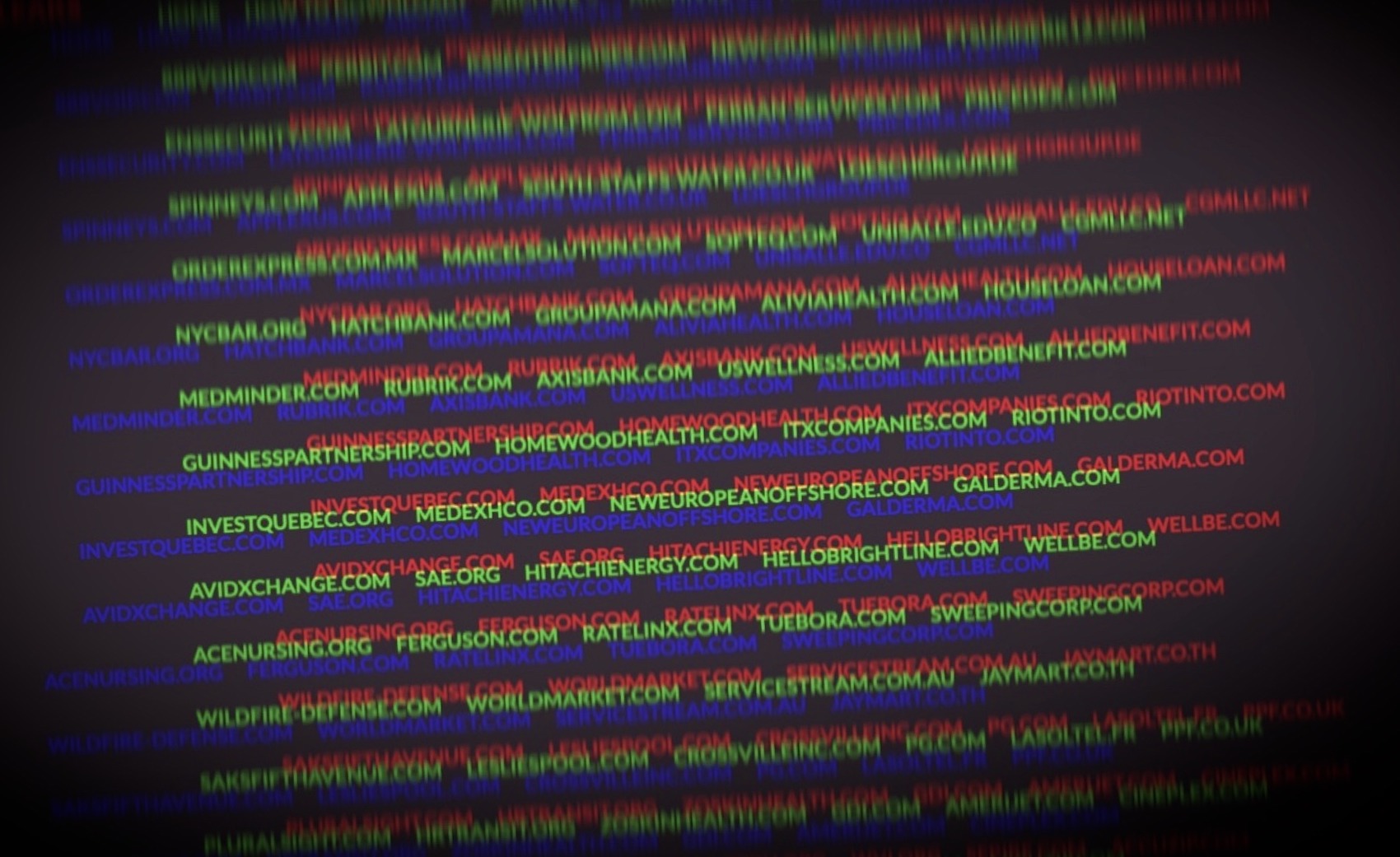 a manipulated photo of the Clop ransomware leaks page, displaying domains targeting by ransomware on a multi-colored blurry text