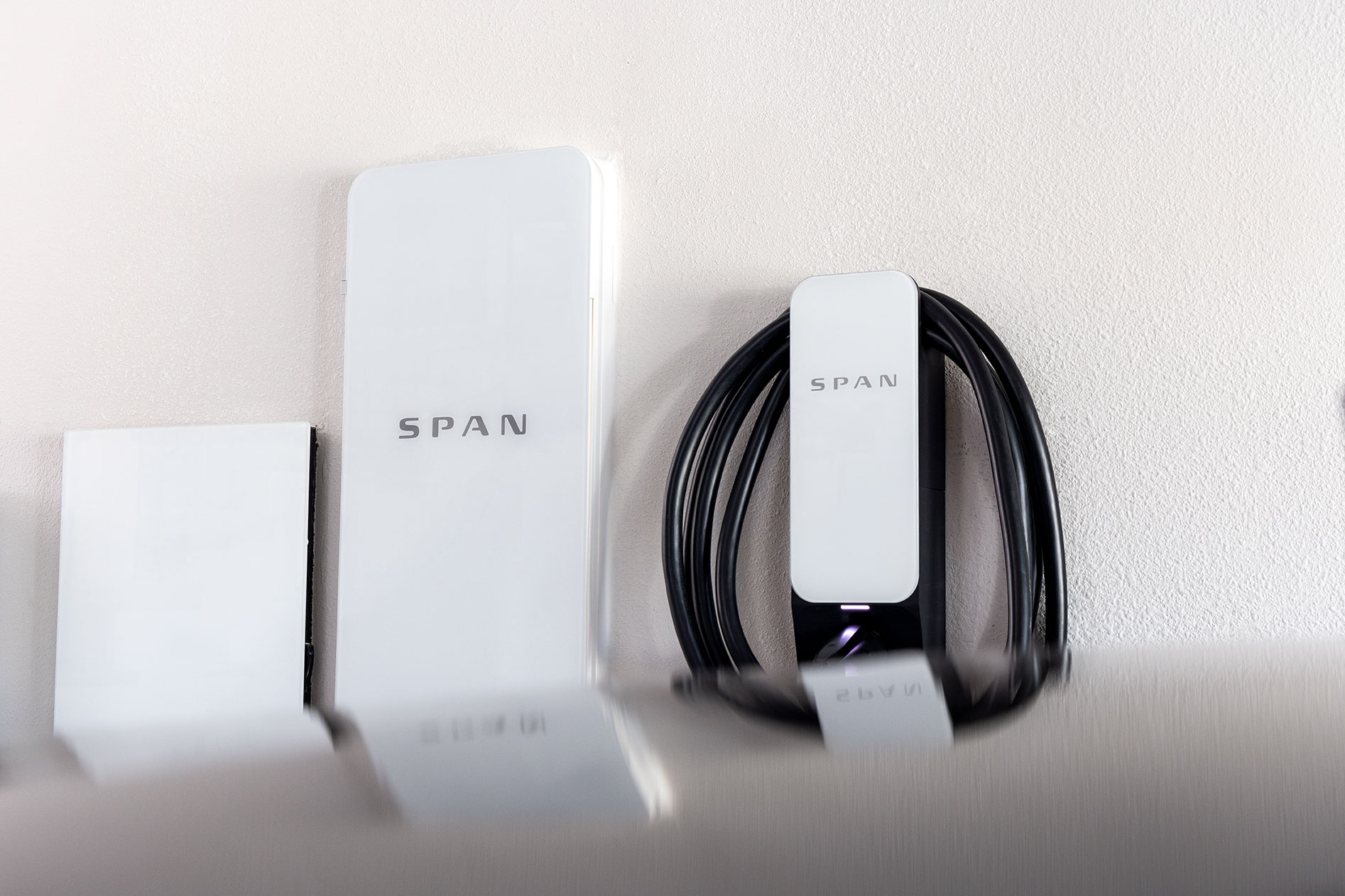 Span electrical panel and EV charger mounted on a wall.