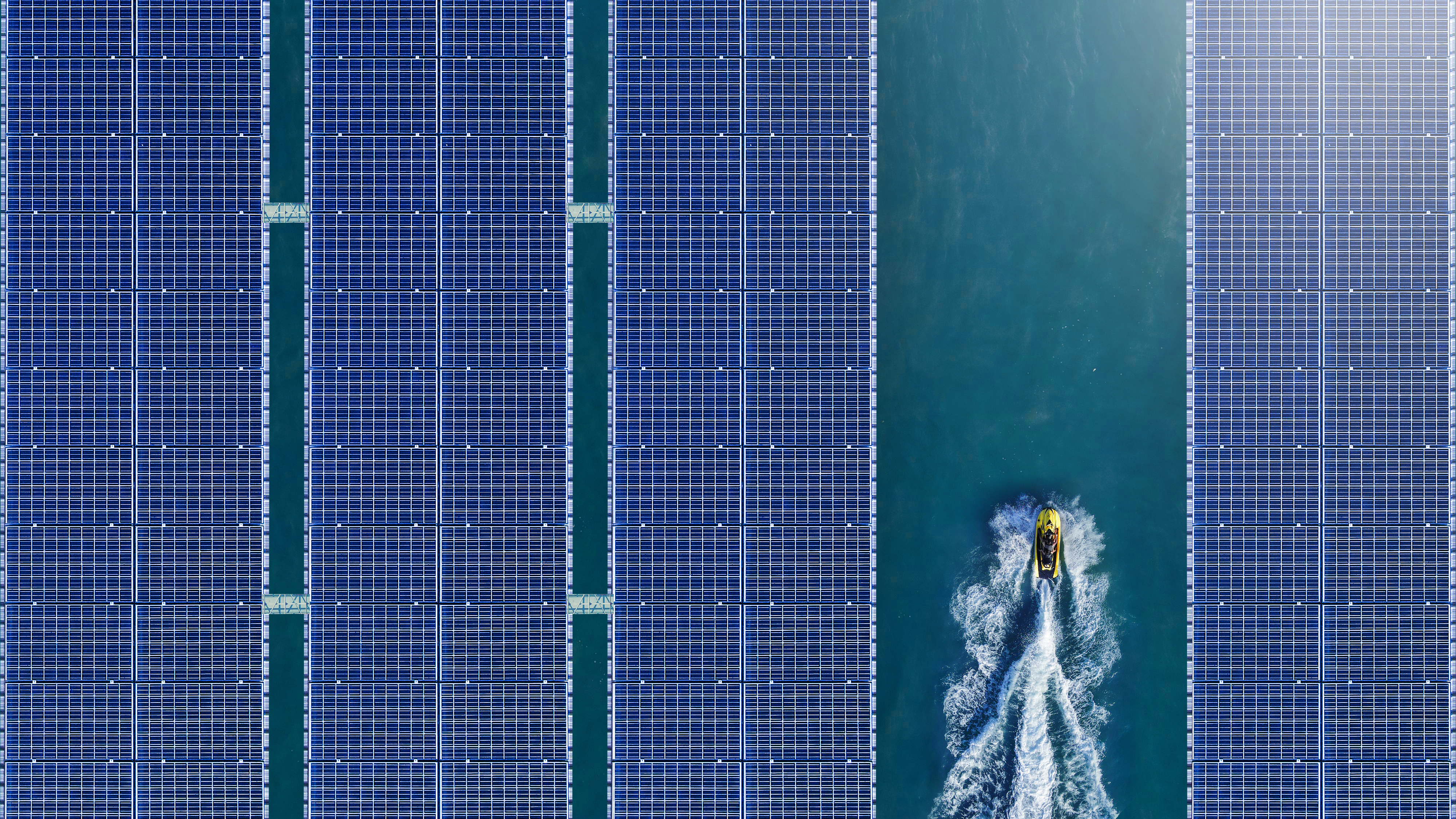 Jet ski moving through floating solar panels.