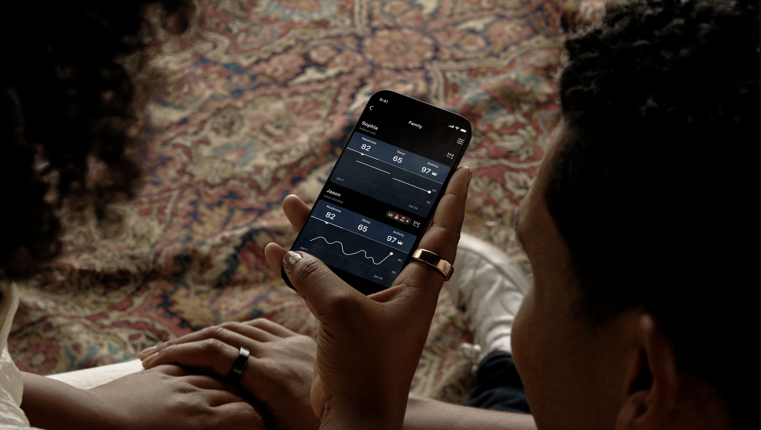 people looking at Oura Circles app on smartphone