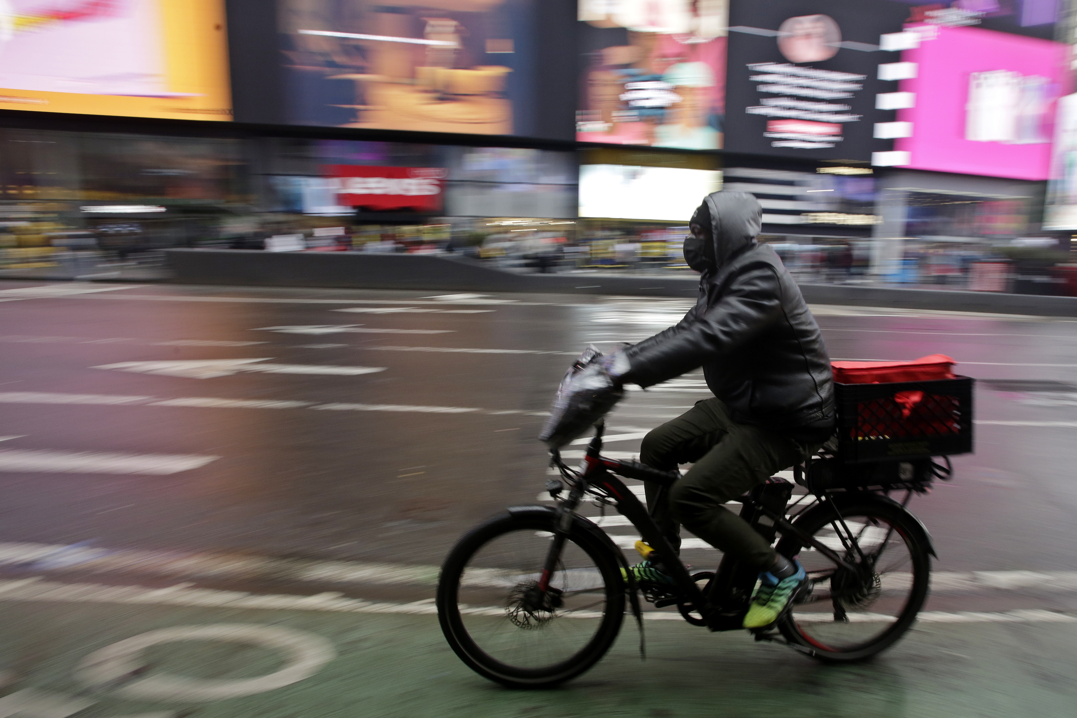 A man rides an e-bike through Times Square