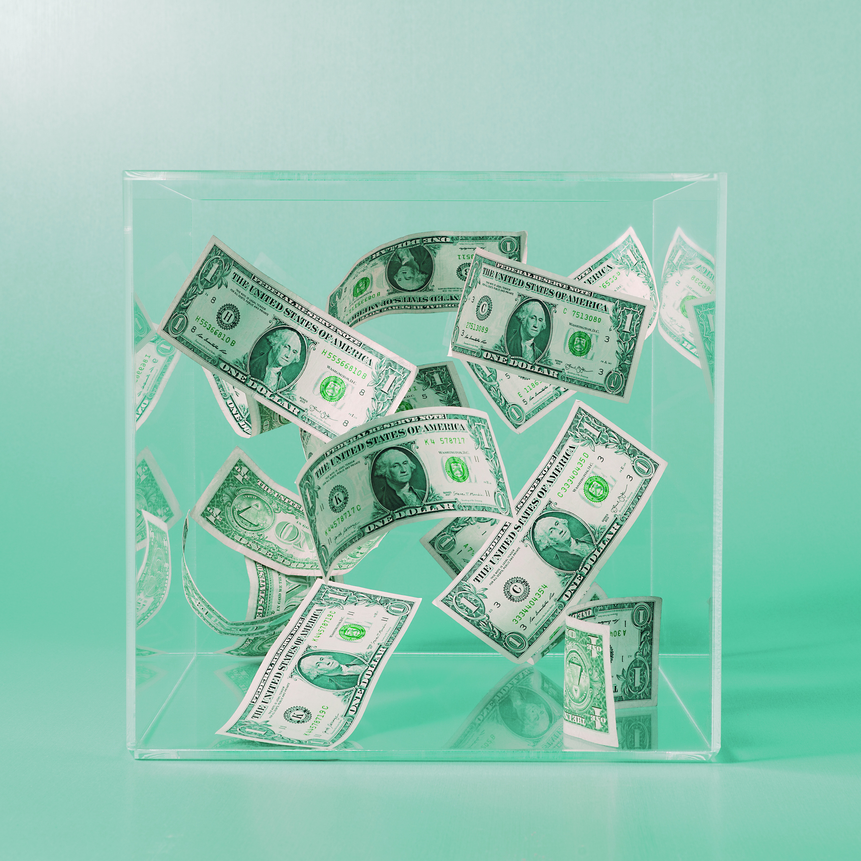 Dollar bills floating in a box