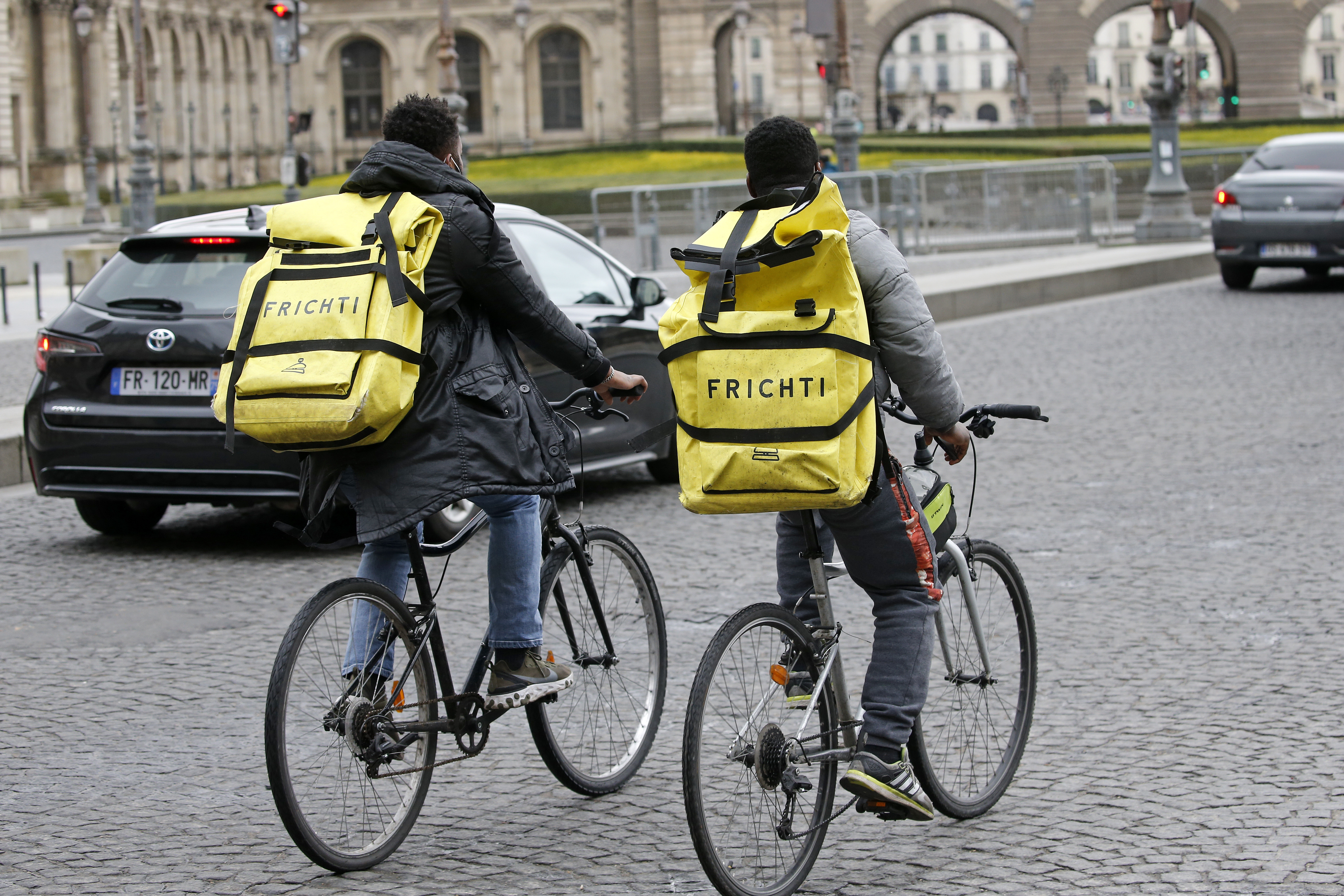 Food deliverers for Frichti ride their bicycles during the coronavirus (COVID-19) outbreak on February 17, 2021, in Paris, France.