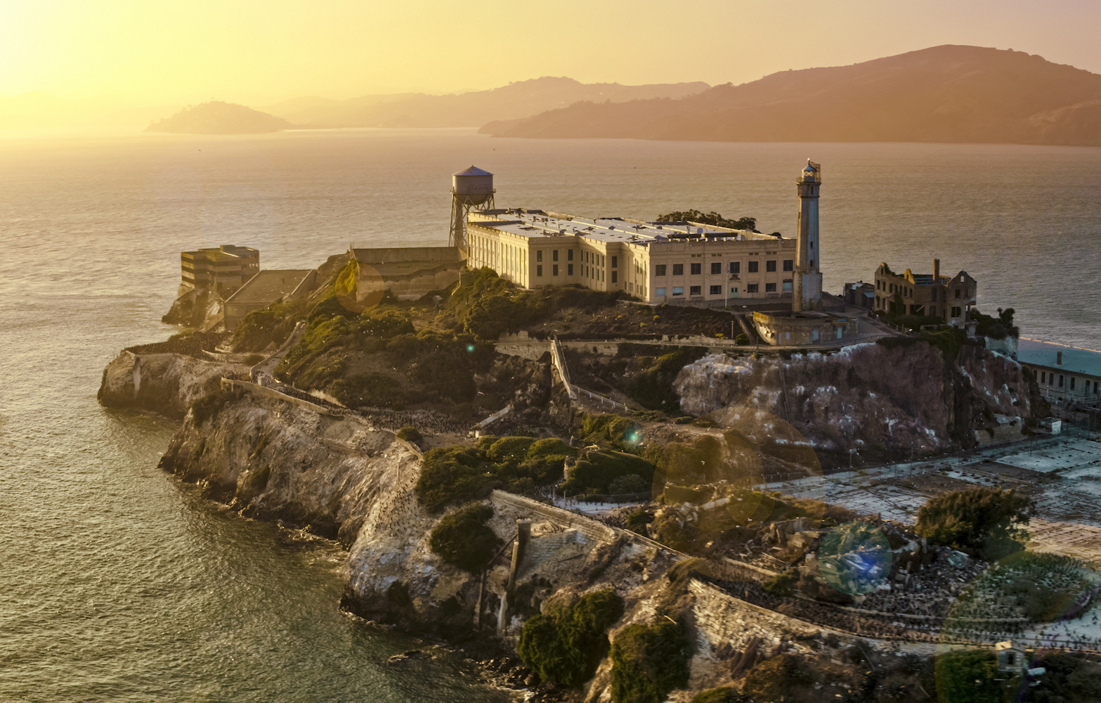Aerial view of prison building on Alcatraz Island during sunset, San Francisco Bay, California, USA.
