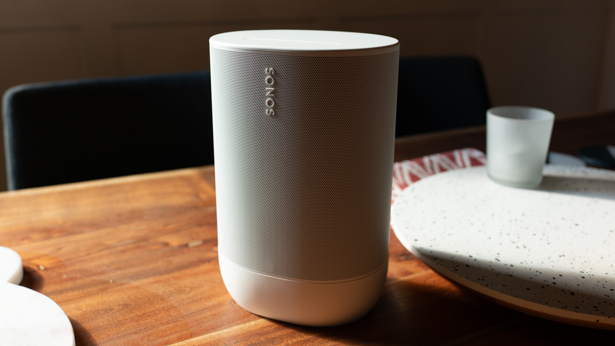 Sonos Move 2 in white, 3/4 view from the right on a wood table indoors