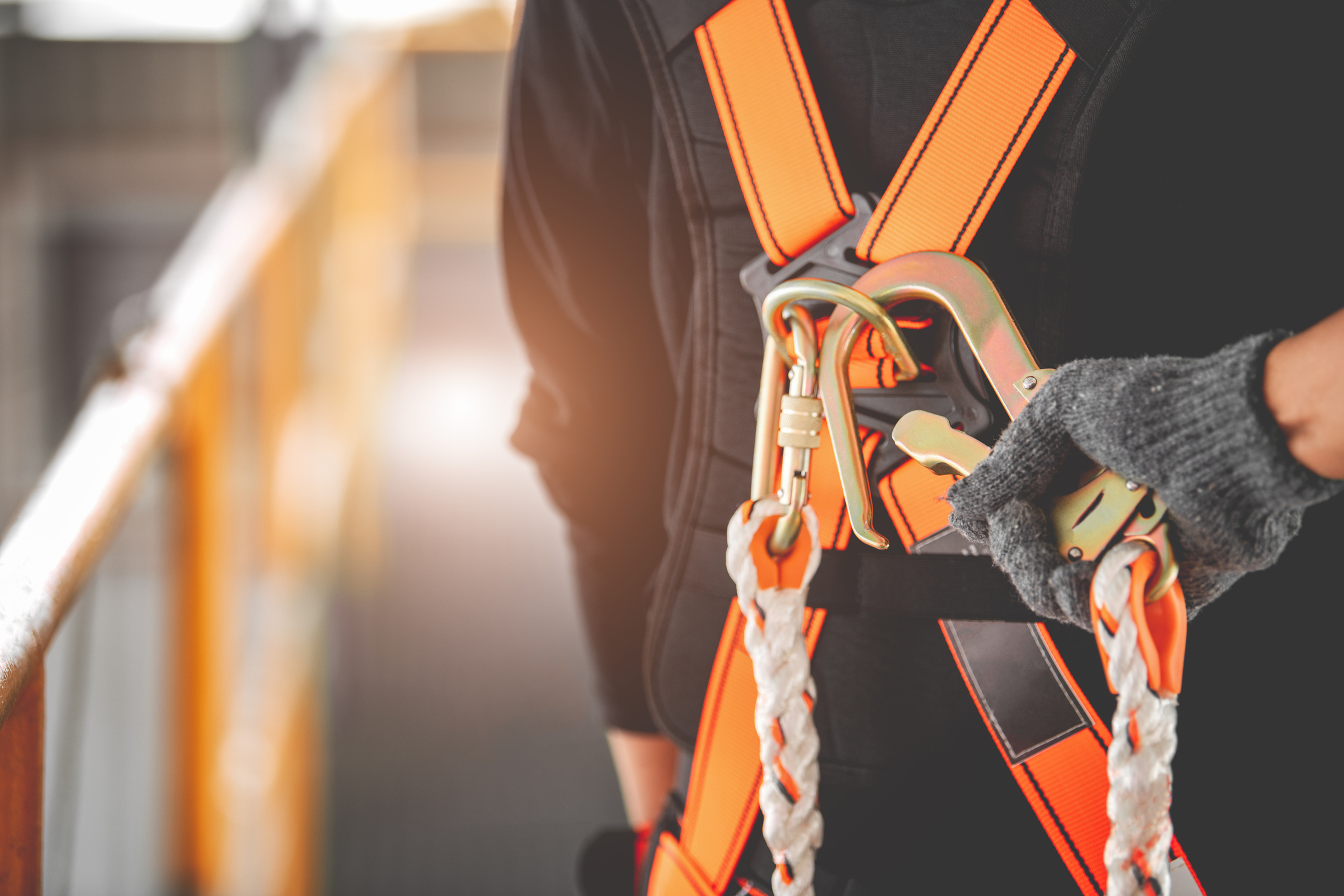 Construction worker wearing safety harness and safety line working high place at industrial.