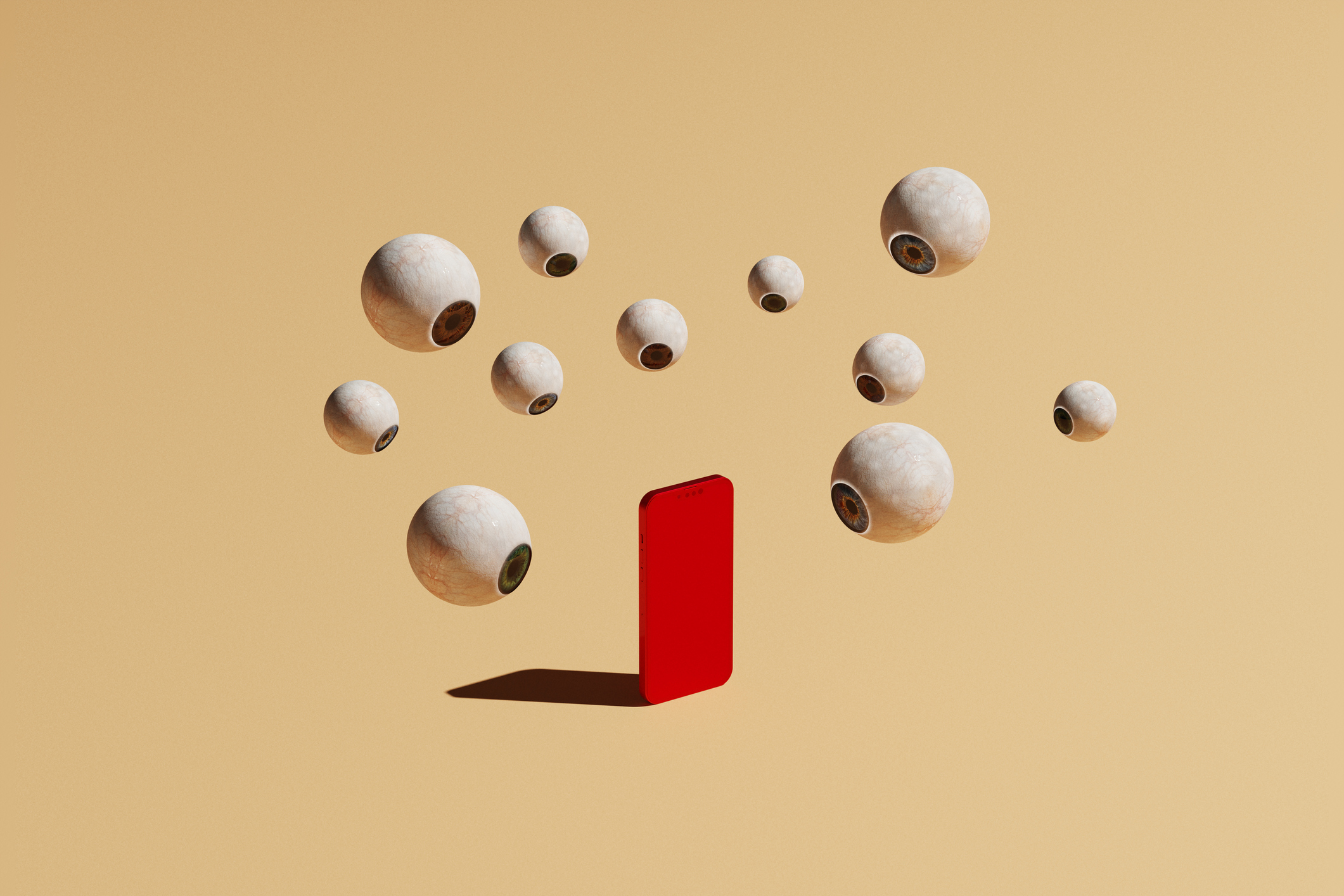 Conceptual image with a bunch of floating eyeballs in different sizes overlooking a red phone, could symbolize ideas around how we are being tracked and watched online on social media