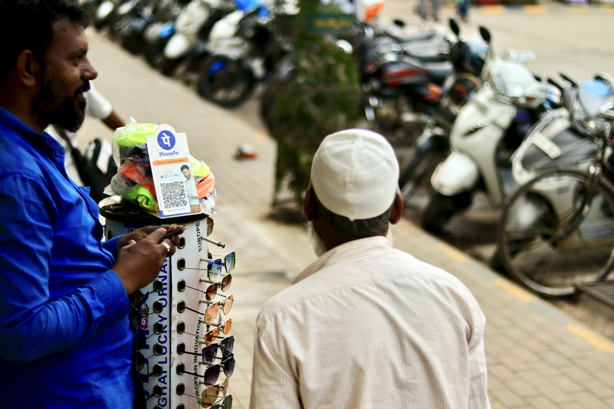 phonepe UPI being used to accept payments at a road-side sunglasses stall.