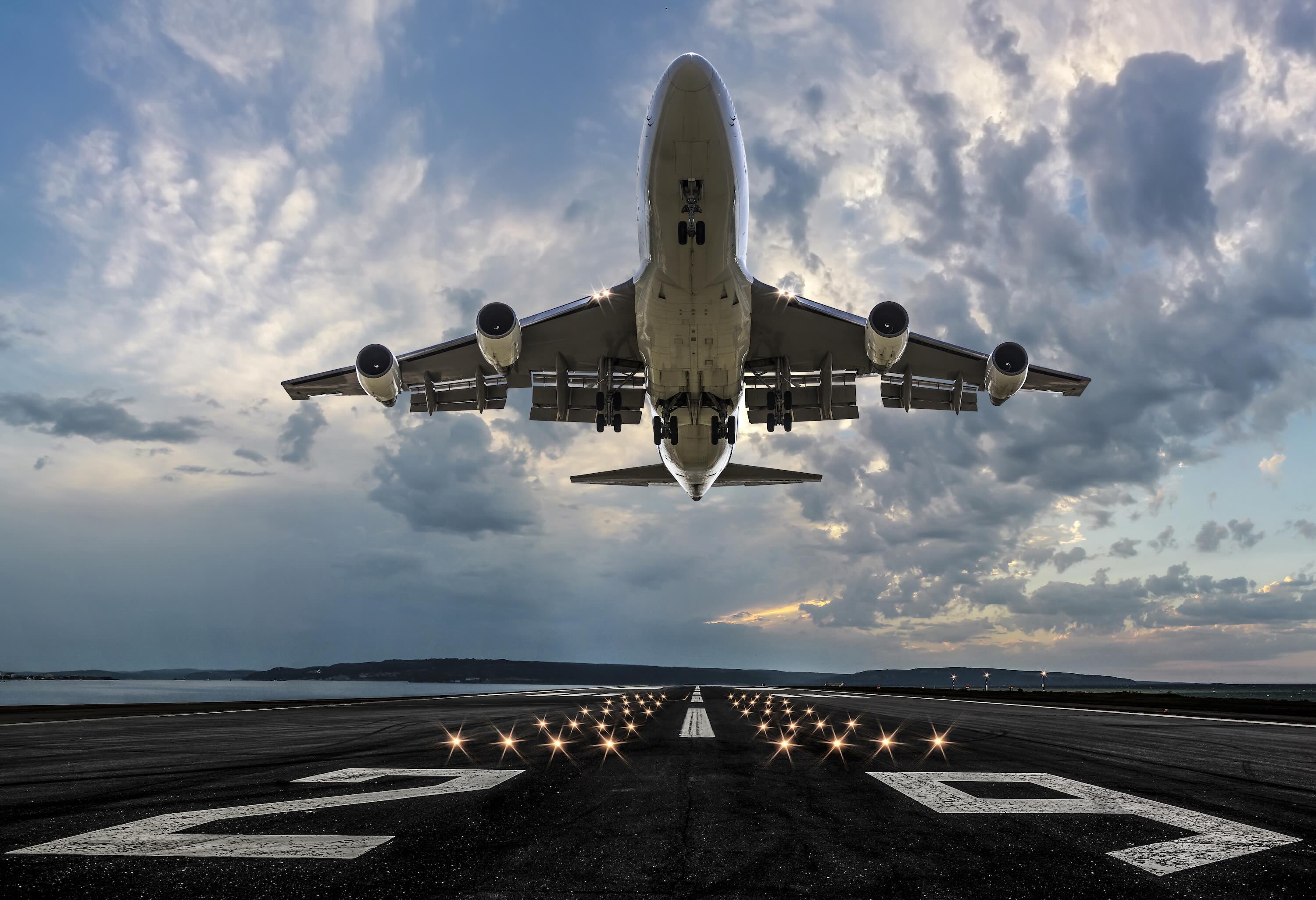 Passenger airplane taking off at sunset.