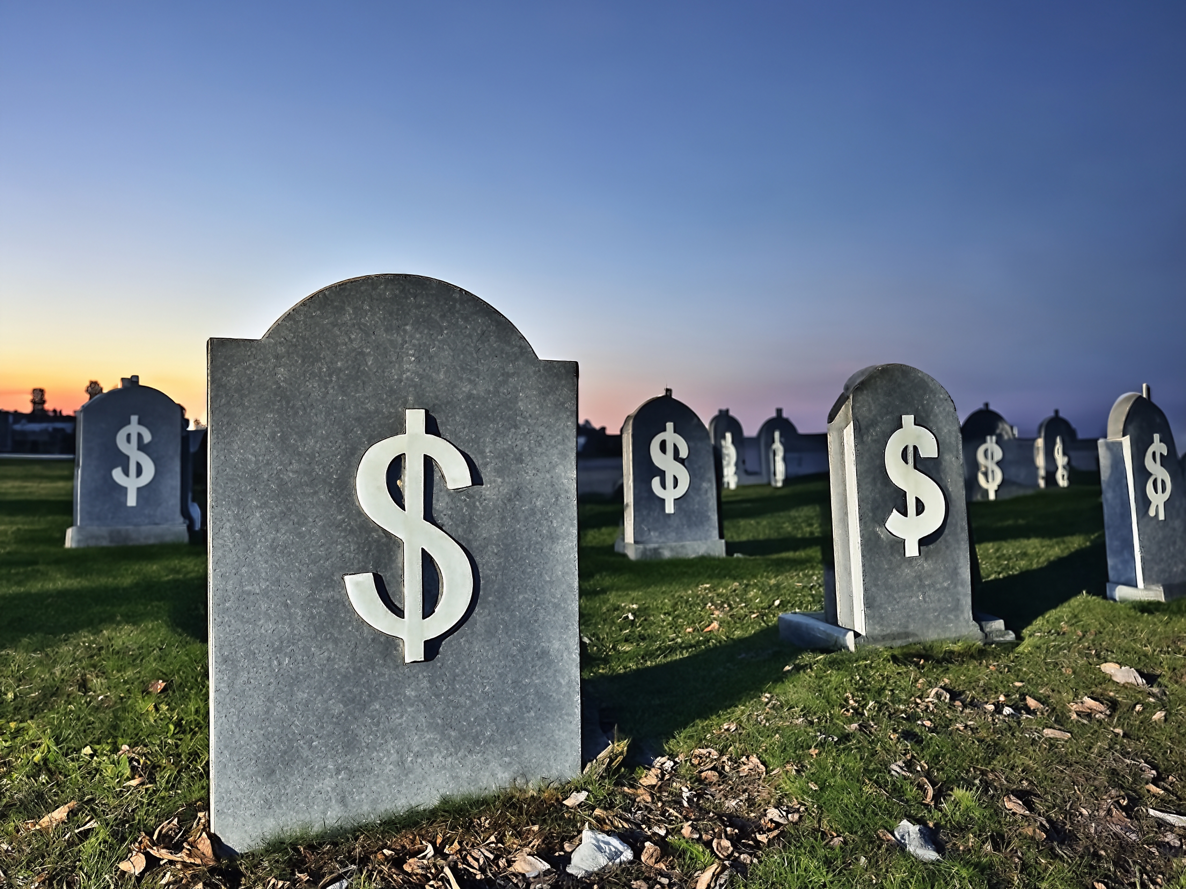 Graveyard headstones with dollar signs
