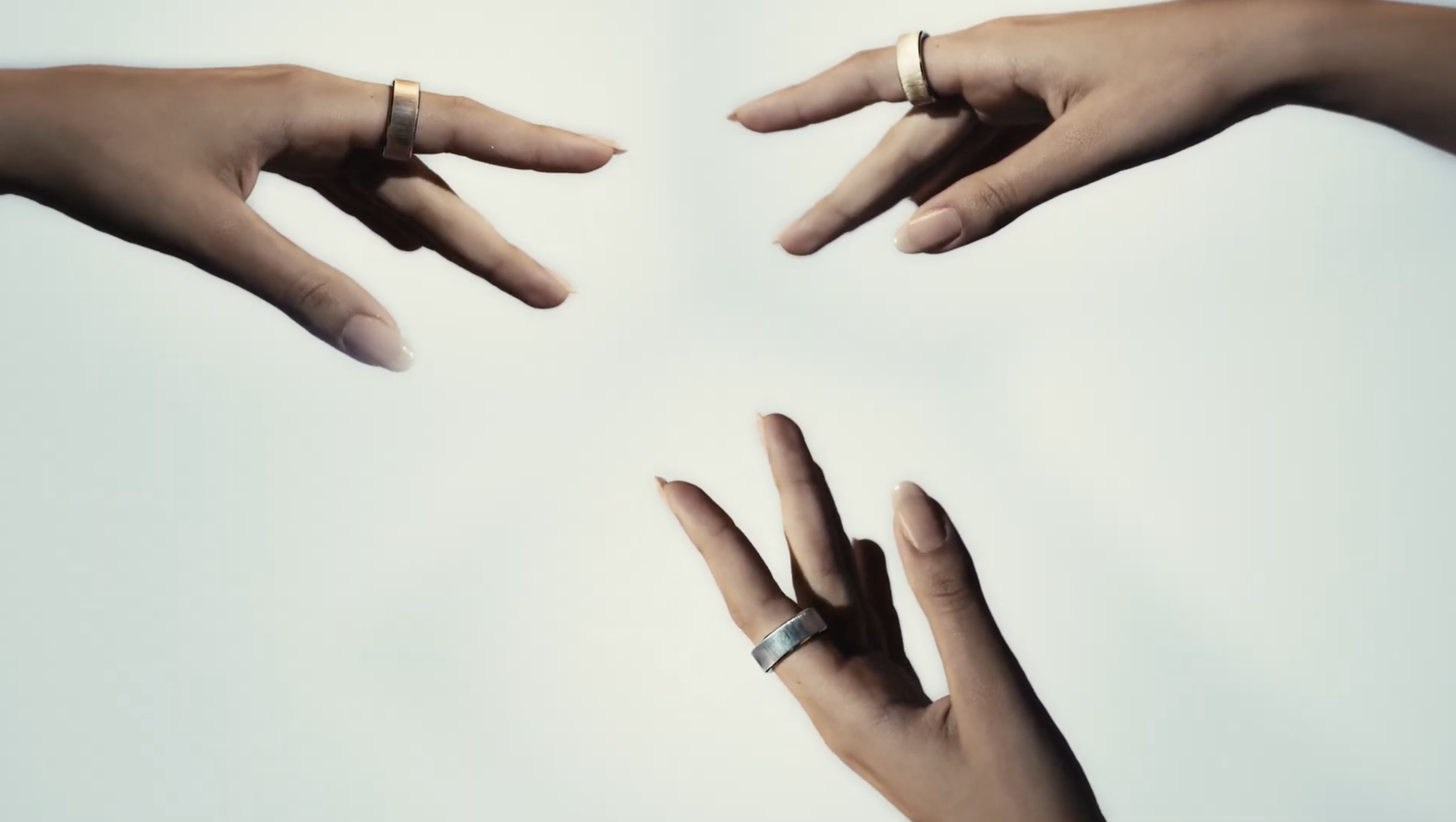 Ultrahuman Rare; three hands, each wearing a smart ring on one finger