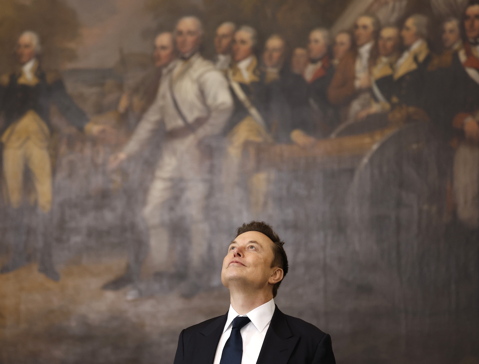 a photo of Elon Musk looking up at the ceiling while standing in front of a historical painting