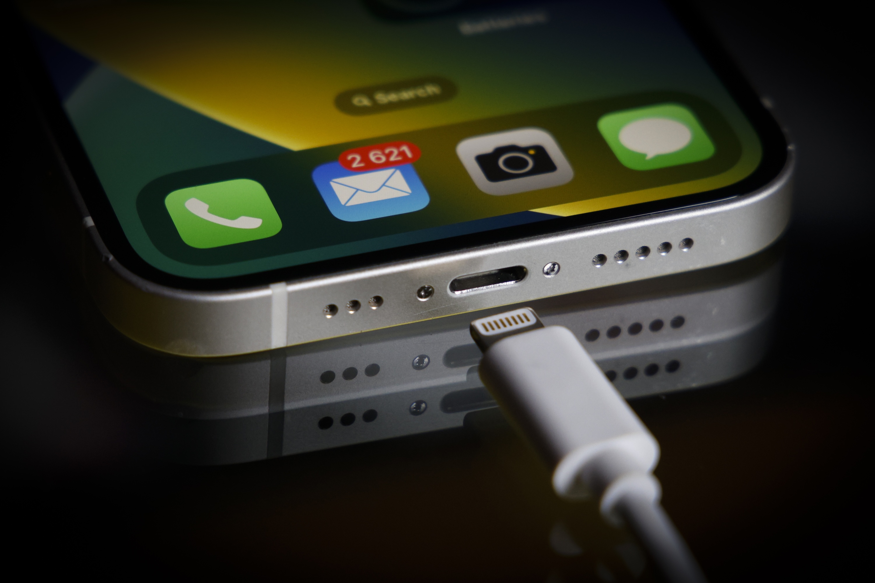 A Apple Lightning port charging cable is seen with with an iPhone in this illustration photo in Warsaw, Poland on 05 October, 2022.