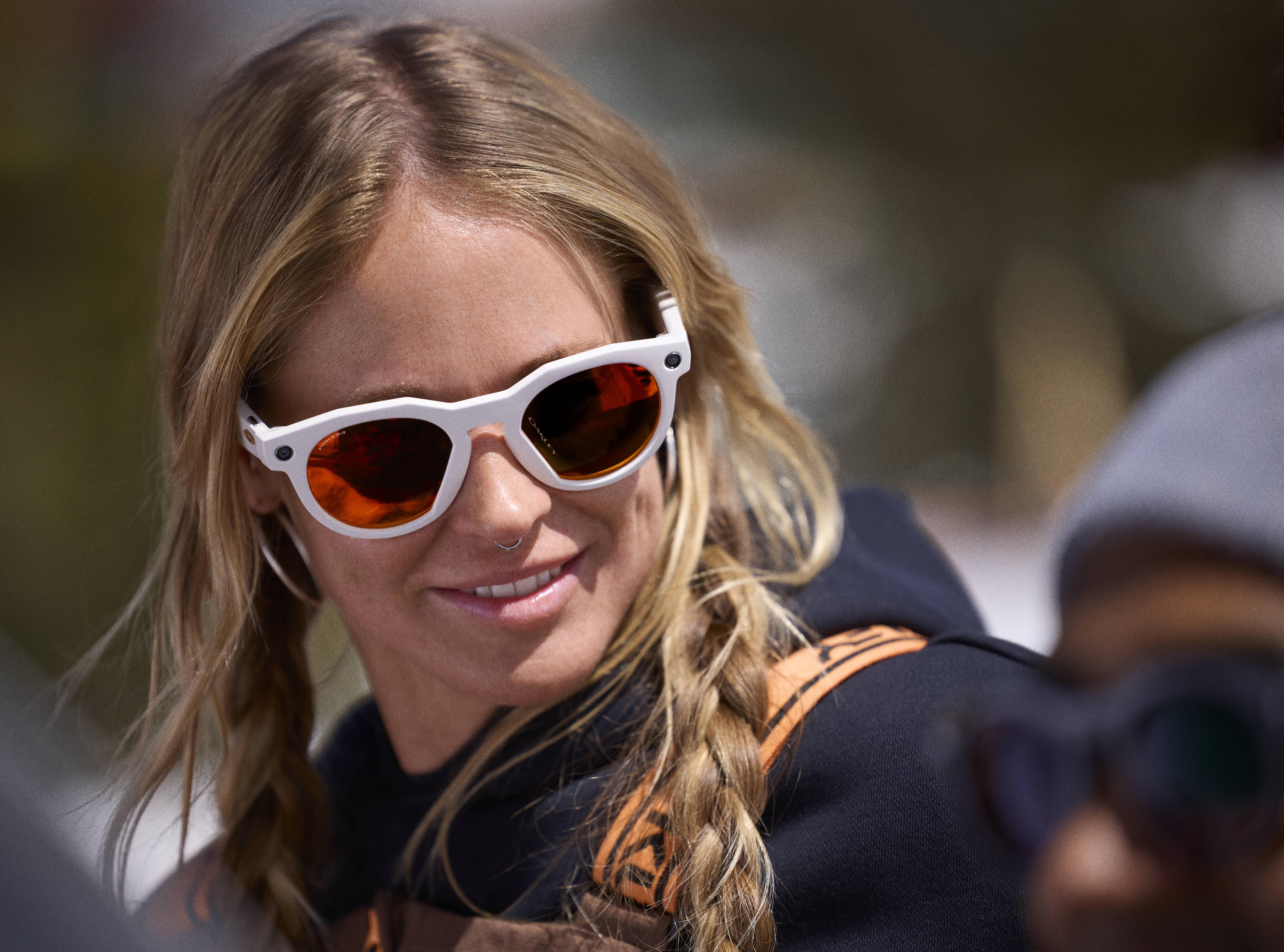 young woman wearing Meta Oakley smart glasses