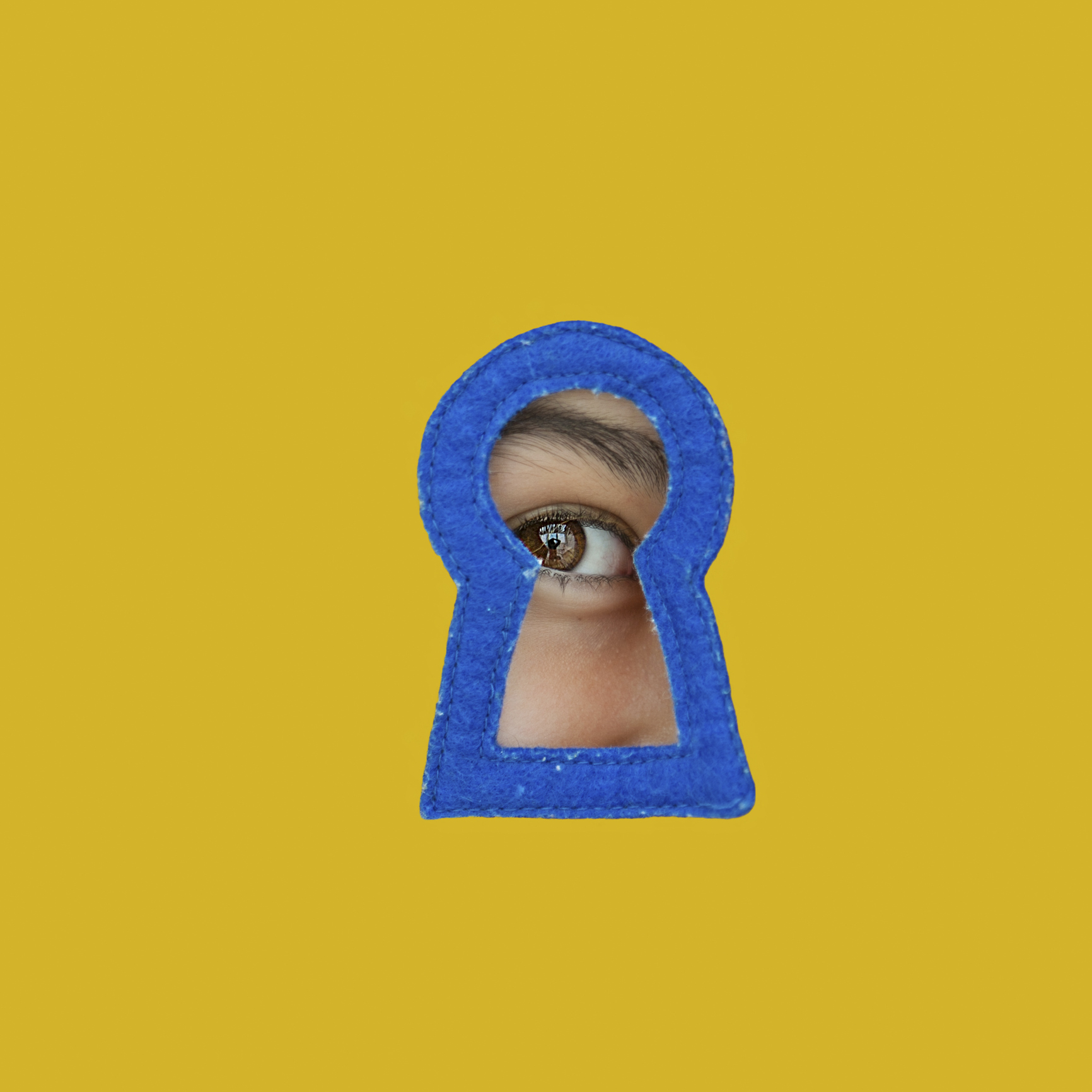 a child looking through a blue keyhole