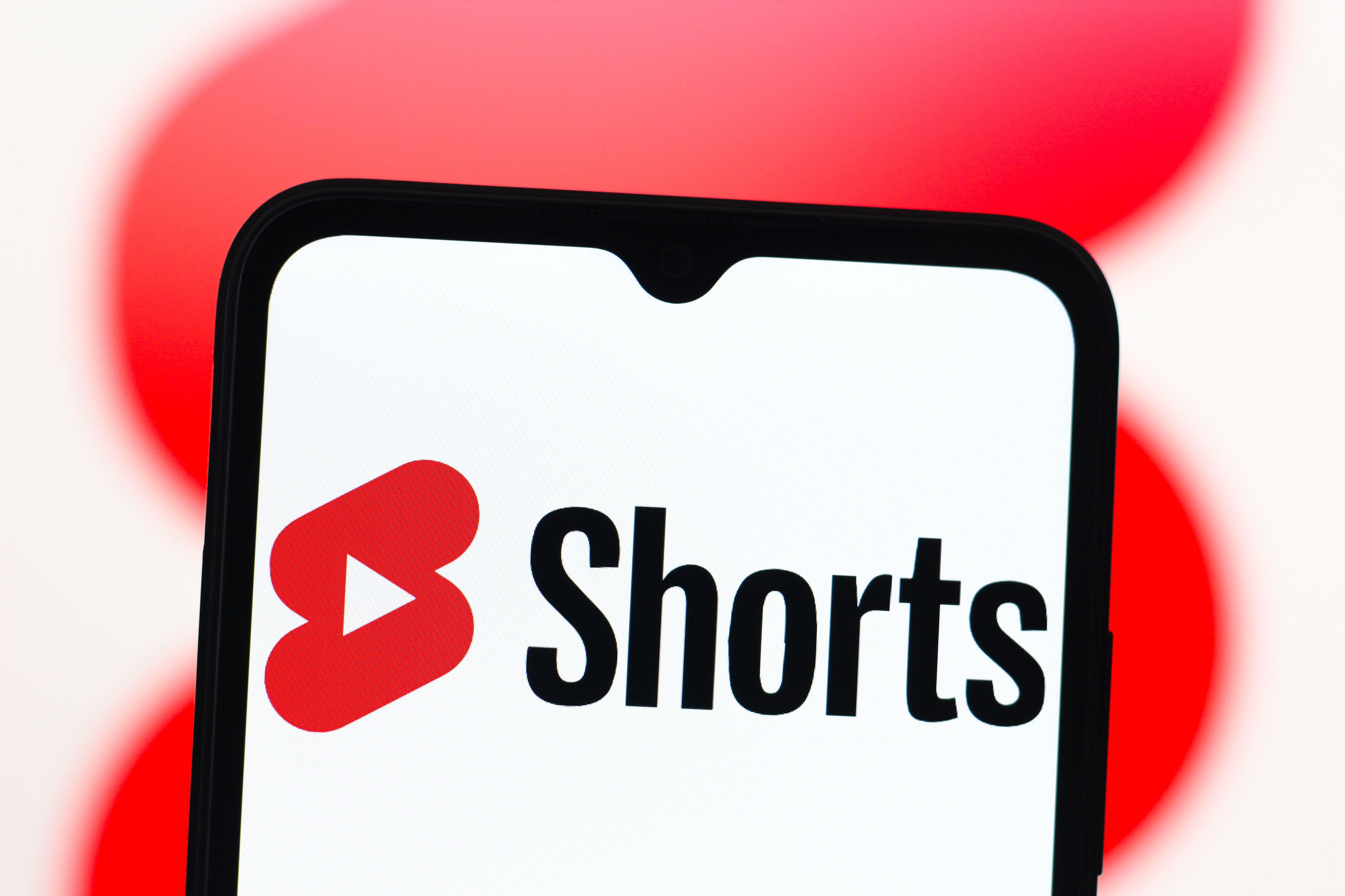 In this photo illustration, the YouTube Shorts logo is seen displayed on a smartphone screen.