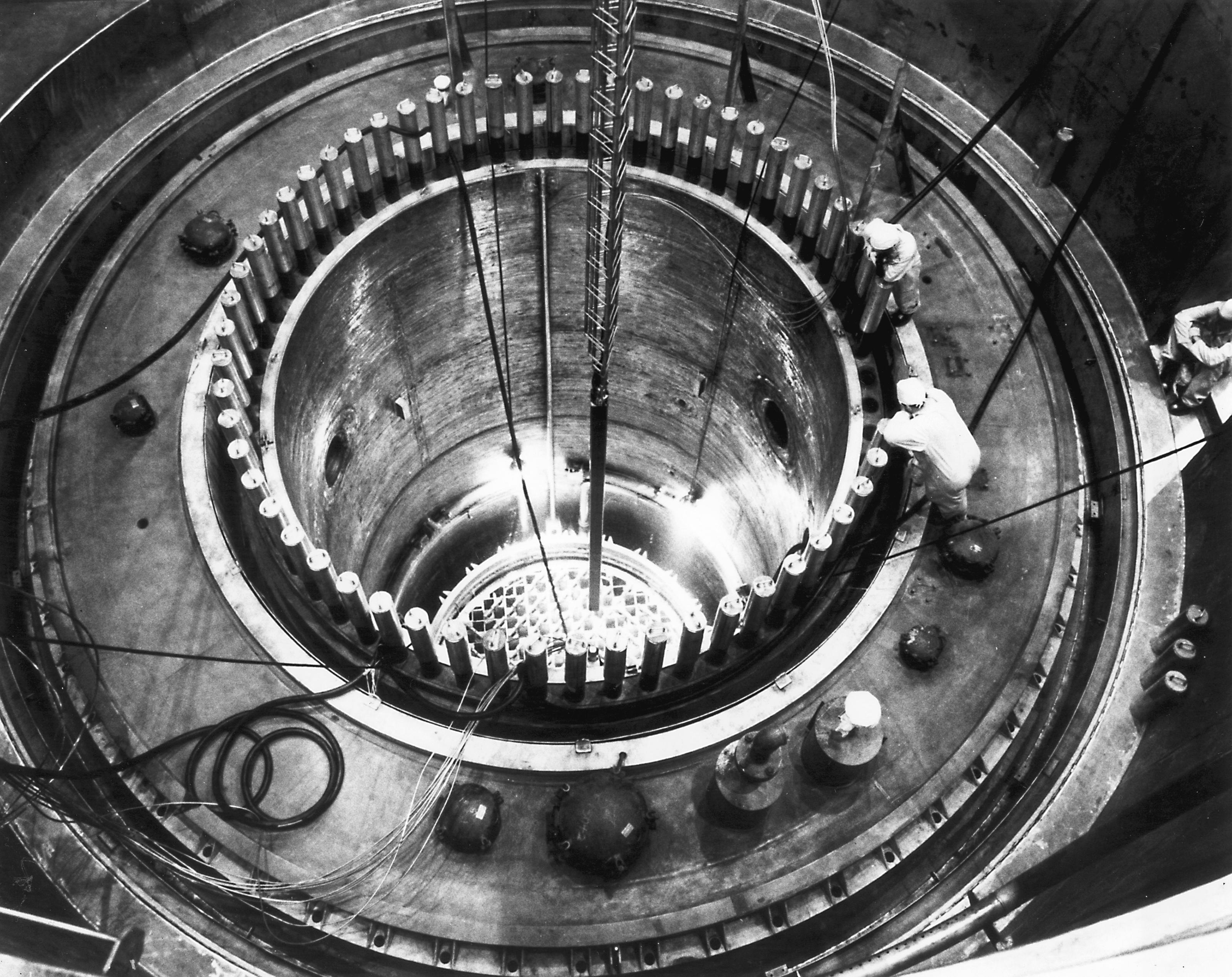 Engineers look inside a nuclear reactor.